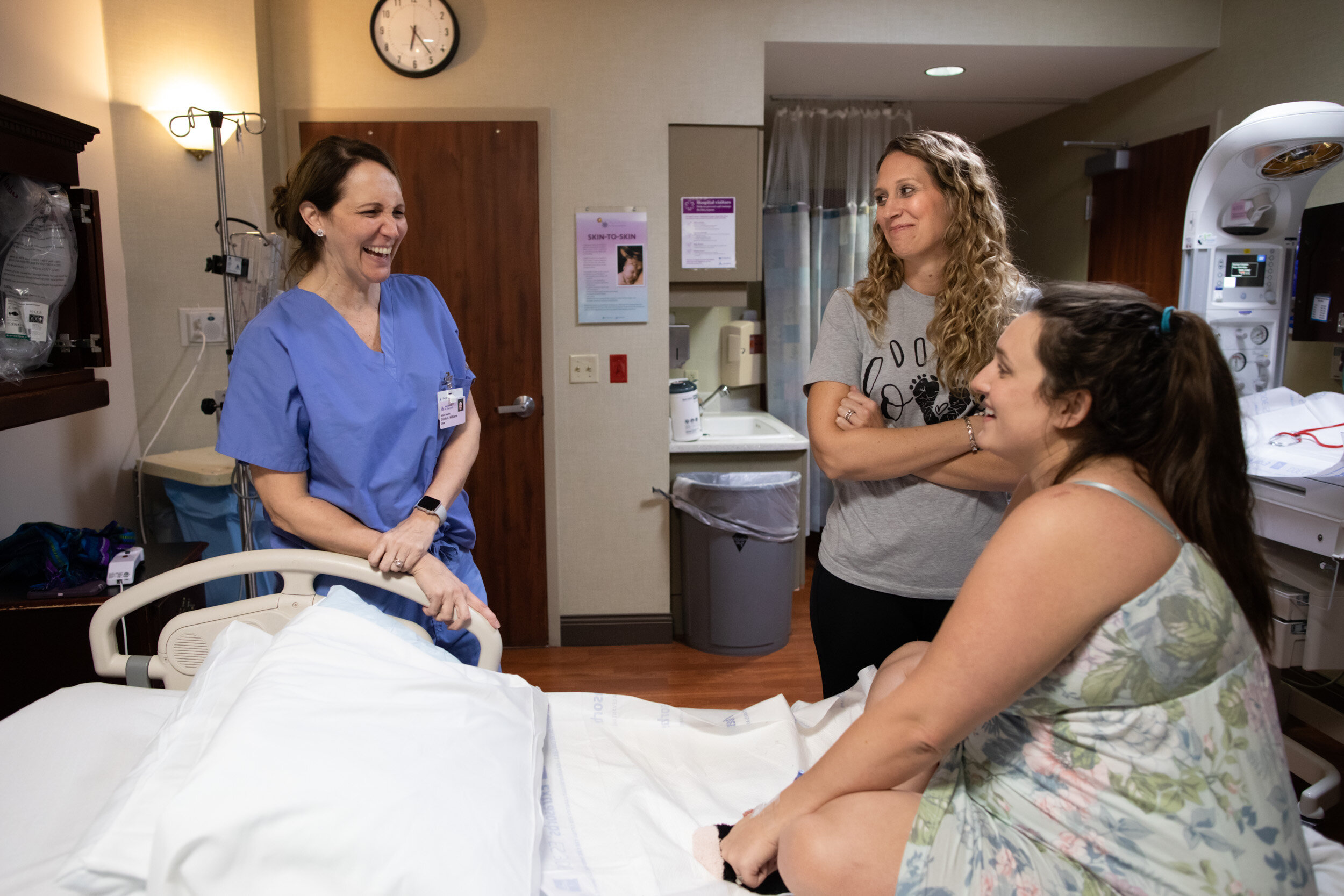 midwife and doula laughing with laboring mom