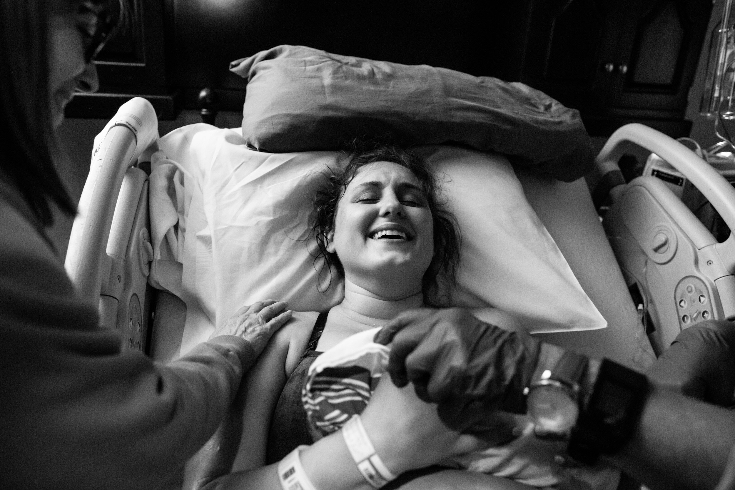 mom smiling with relief just after birth