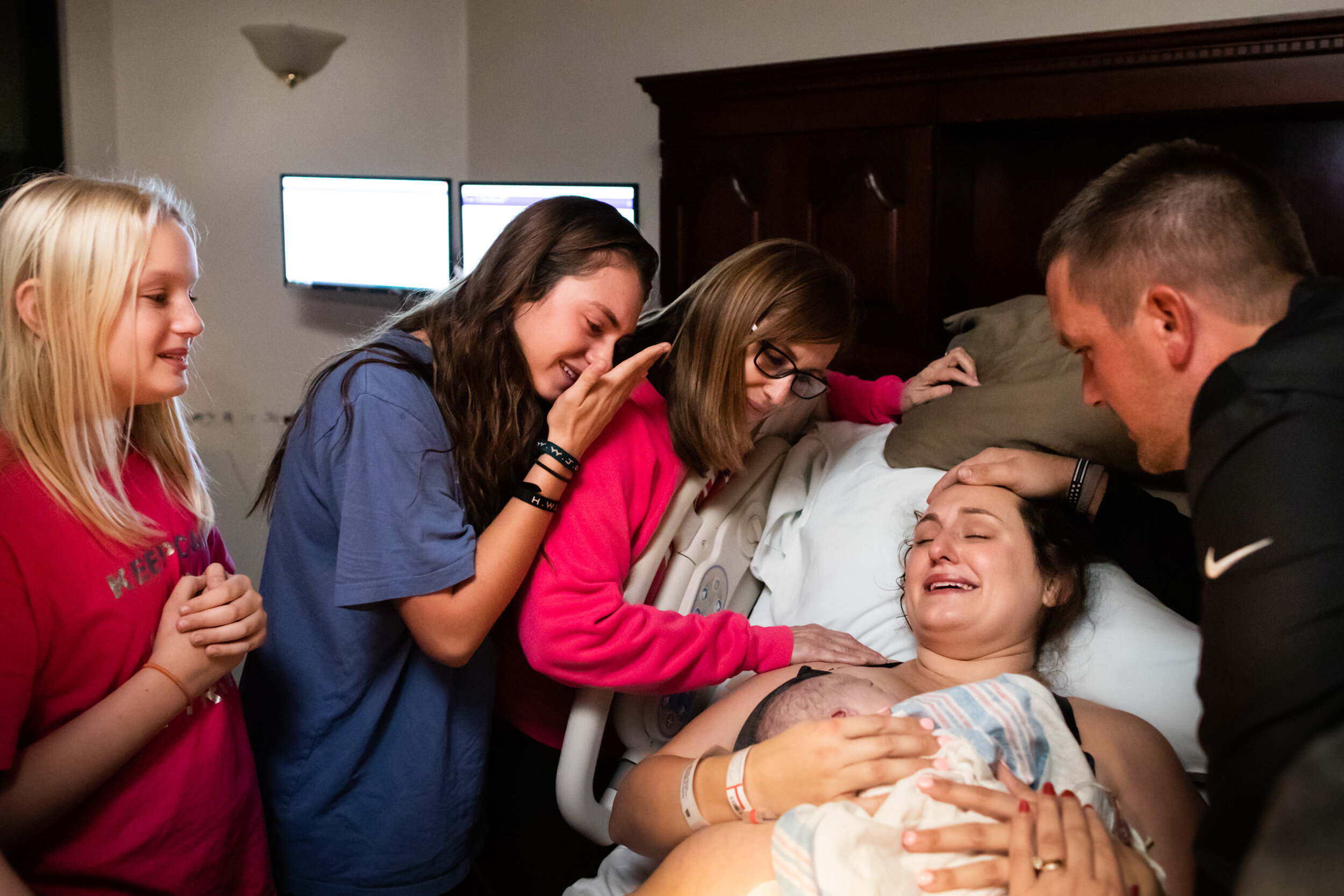 family crying at the sight of the newborn baby boy