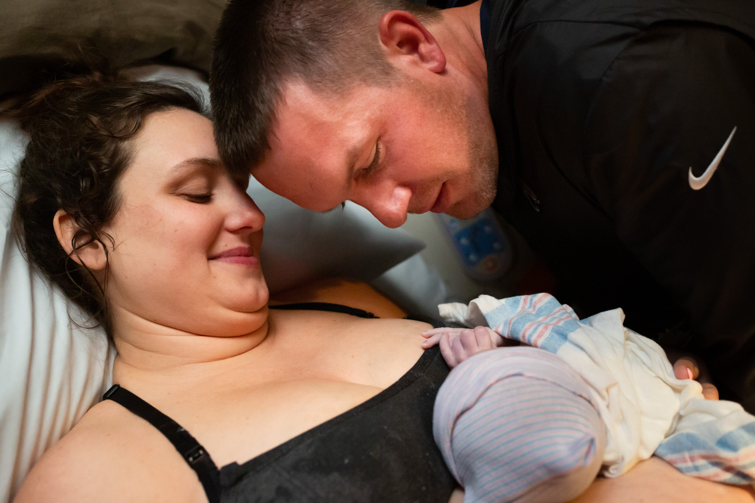 new mom and dad looking at newborn baby boy