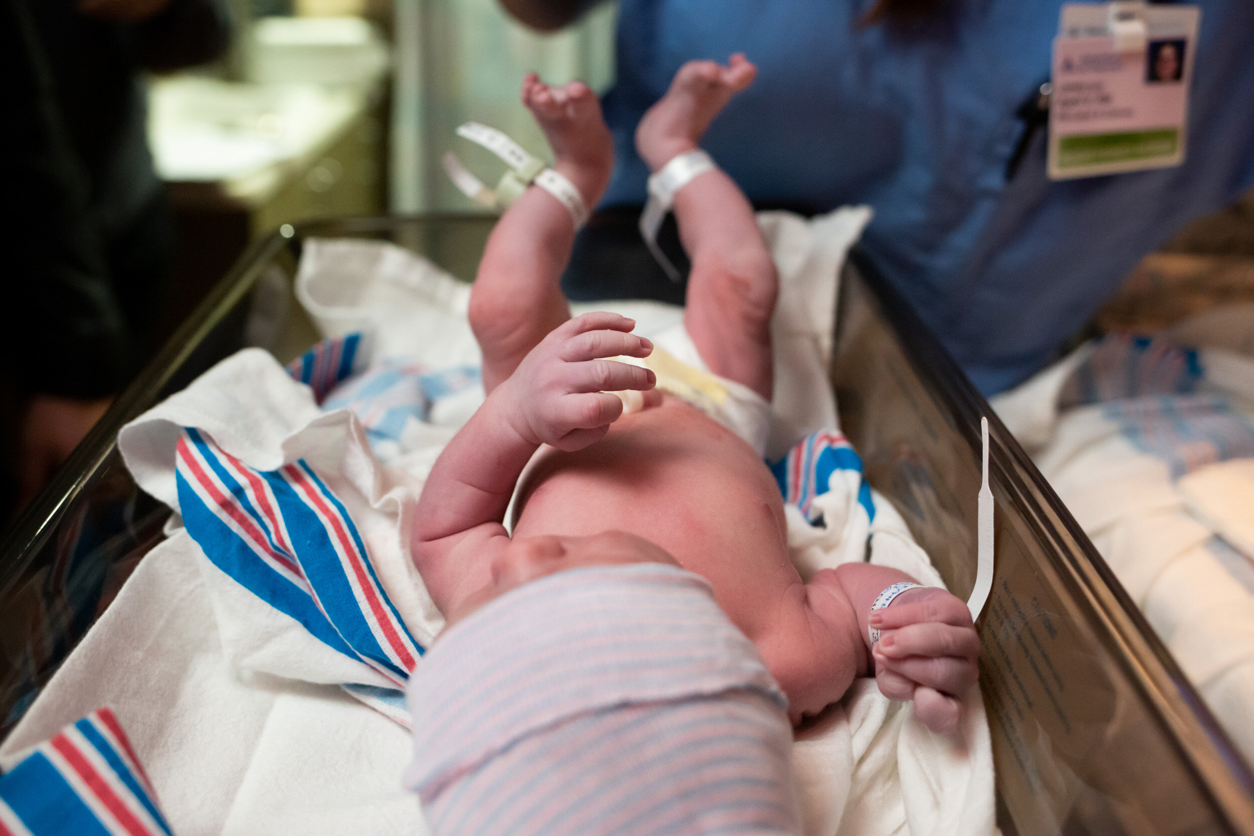 newborn baby boy being assessed by nurses