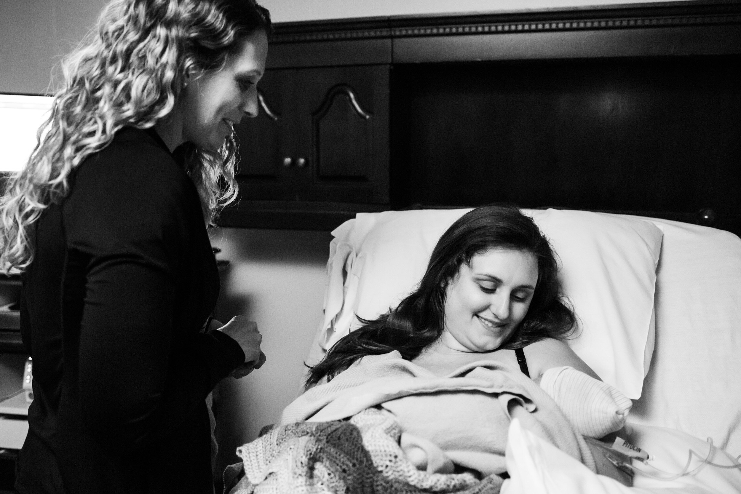 jacksonville doula looking at newborn baby and smiling
