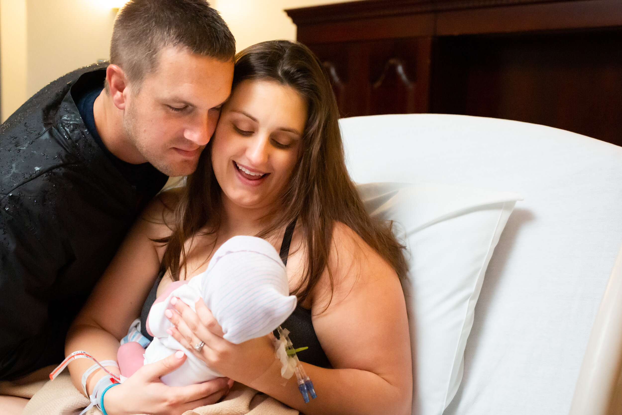 jacksonville parents looking at their newborn son and smiling