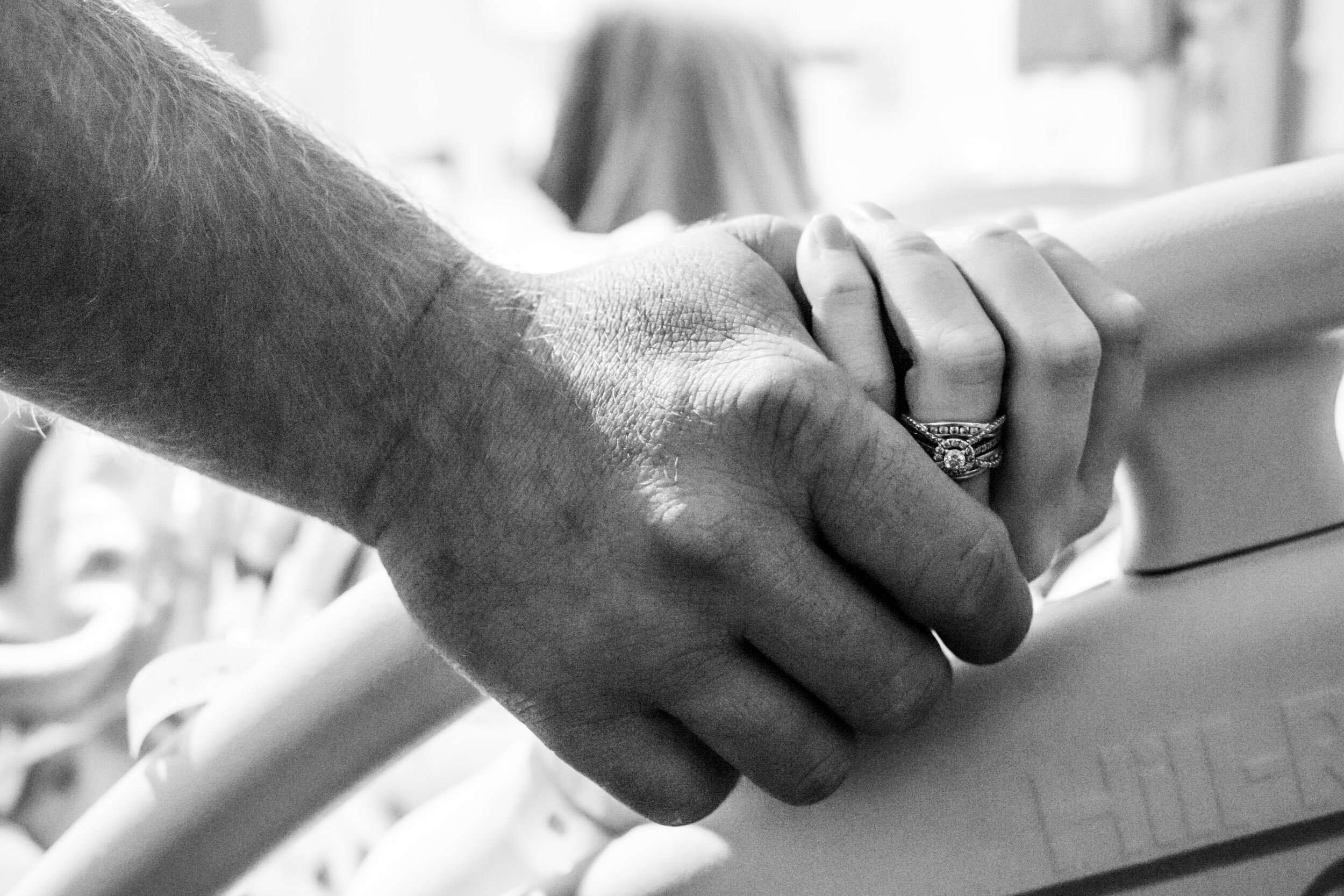 husband holding wife's hand while she's in labor