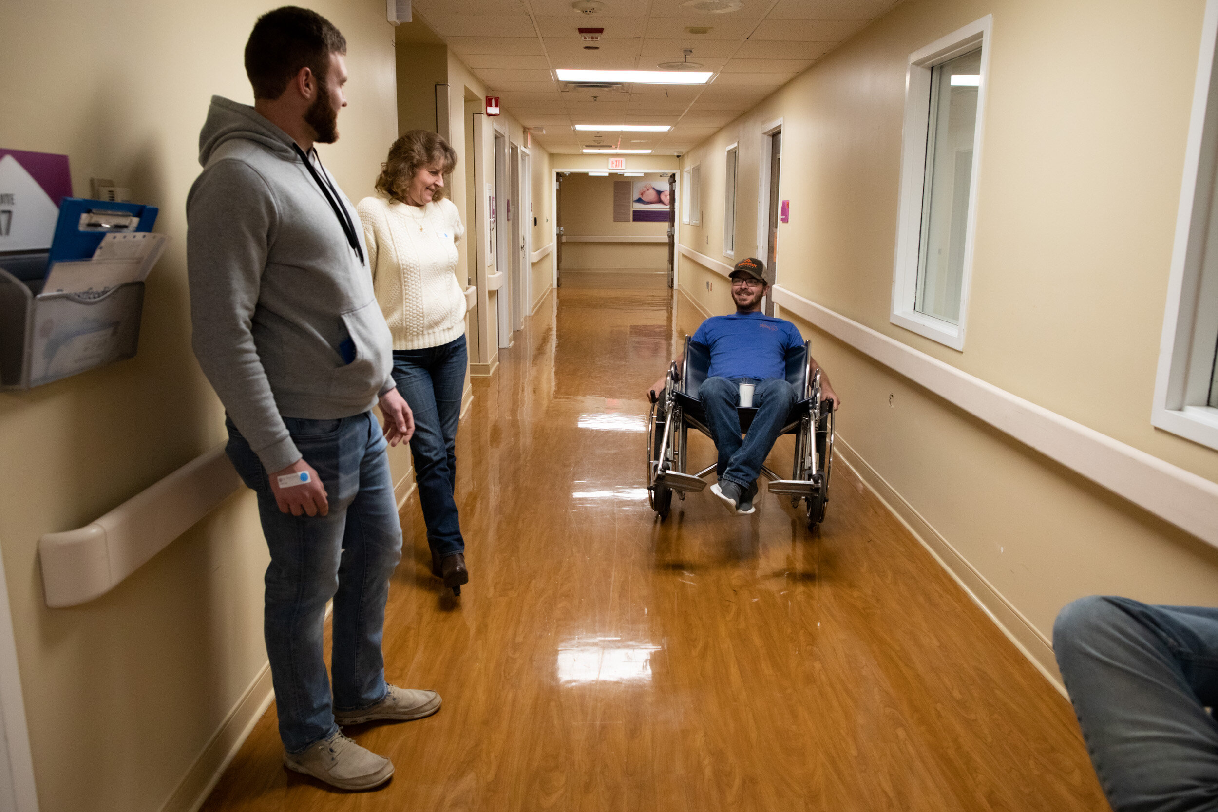soon-to-be dad playing in wheelchair in hospital hallway
