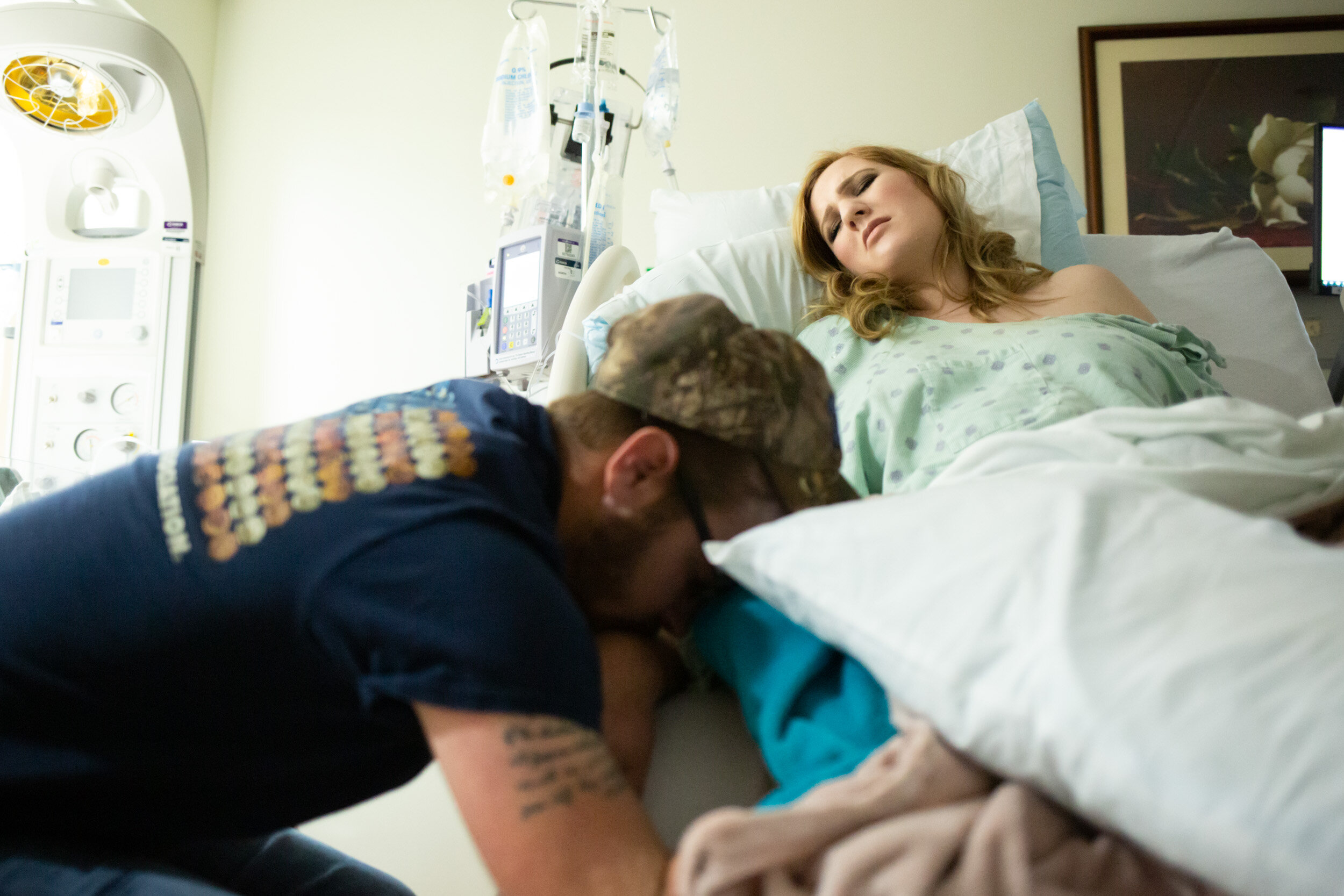 laboring mom resting in between contractions with husband at her side