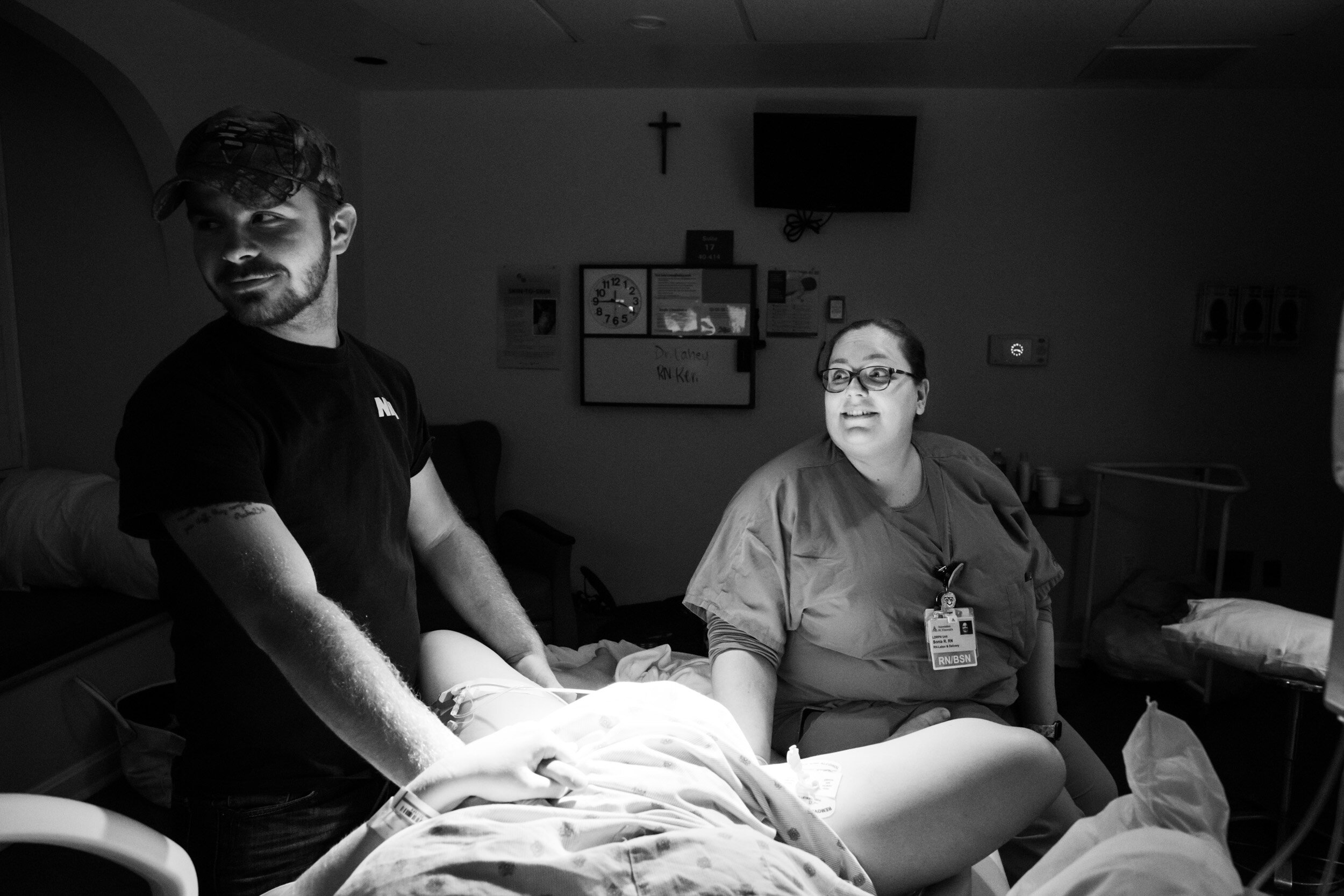 husband and nurse watching the hospital monitors for the next contraction
