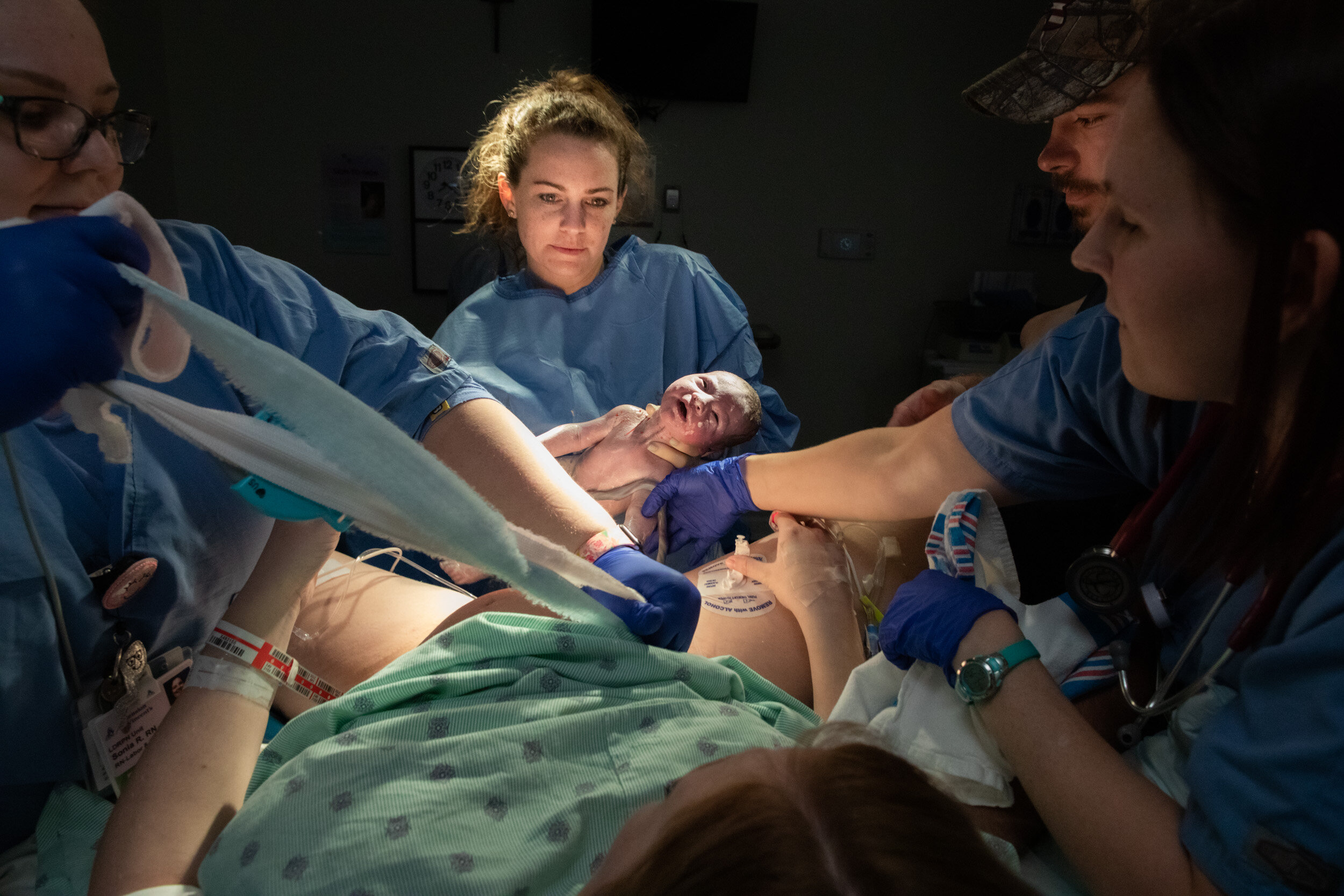 doctor holding up baby just after birth in a jacksonville hospital