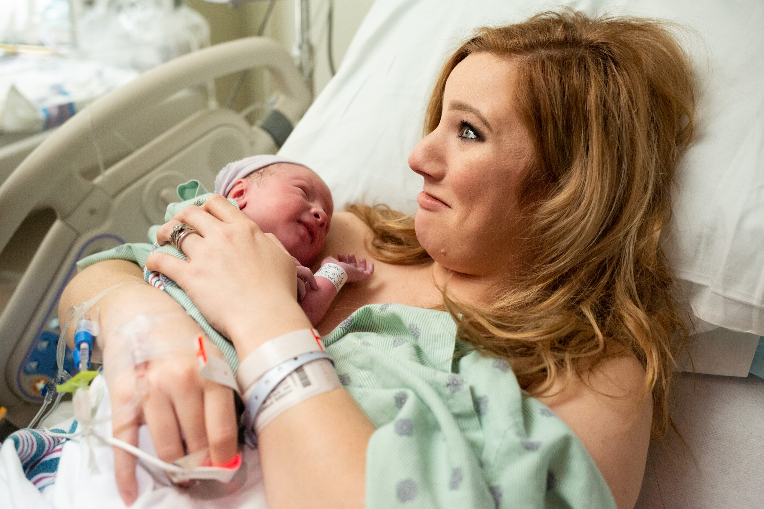 new mom smiling in disbelief after birthing her baby boy