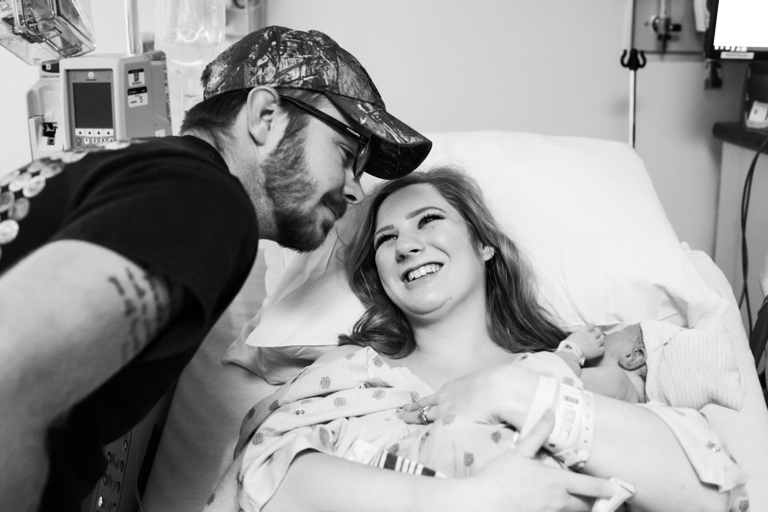 jacksonville mom smiling at her husband after baby was born