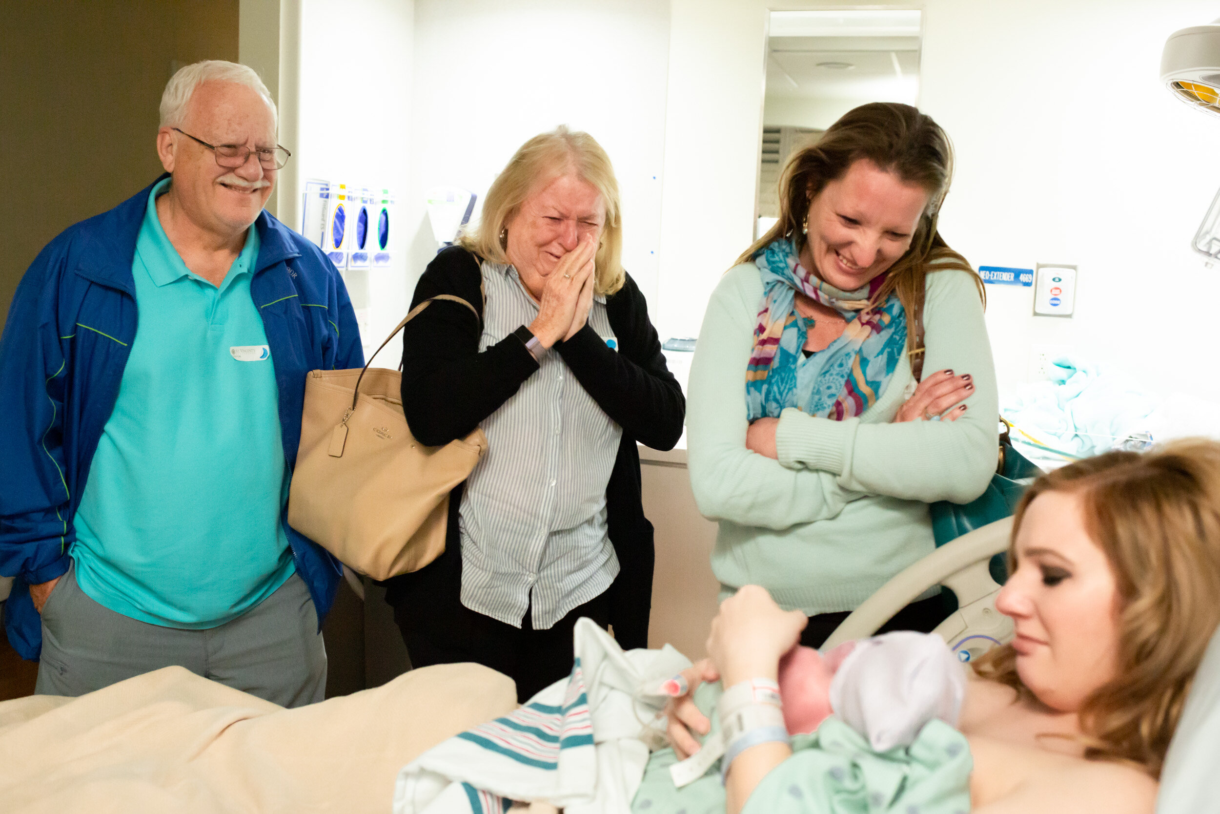 family admiring the newborn addition to their family