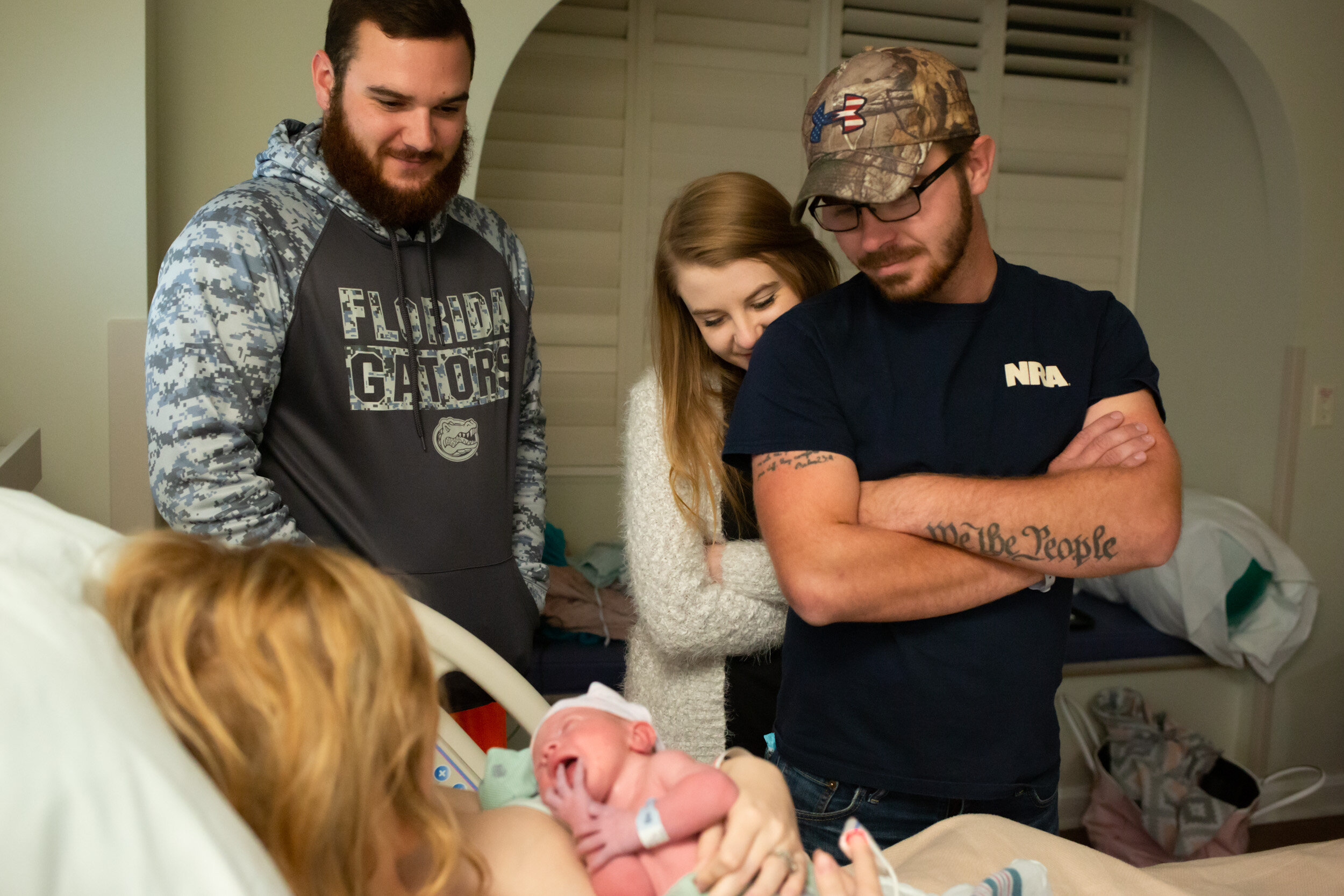 family and friends visiting newborn baby