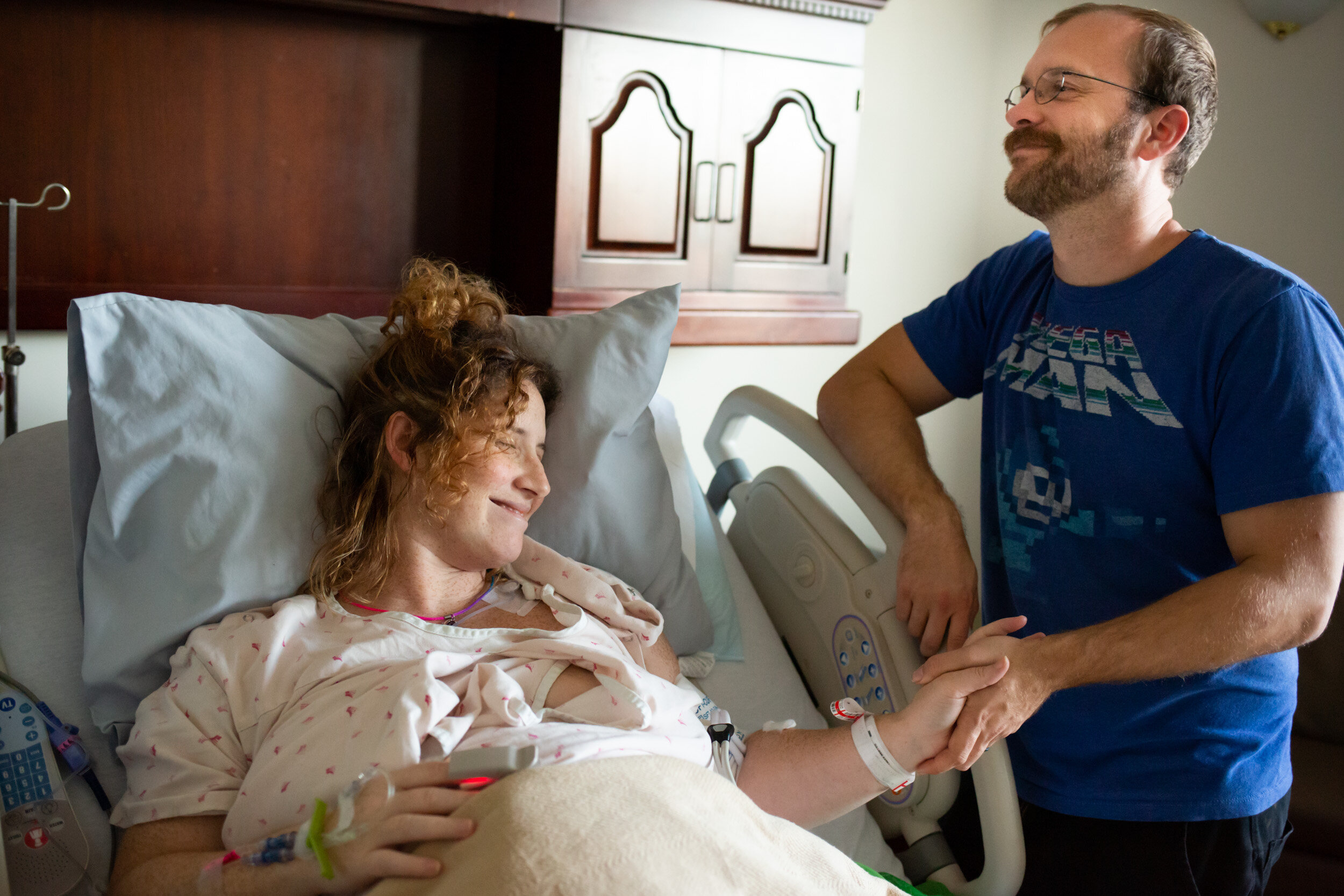 husband and wife holding hands in jax hospital while waiting for birth