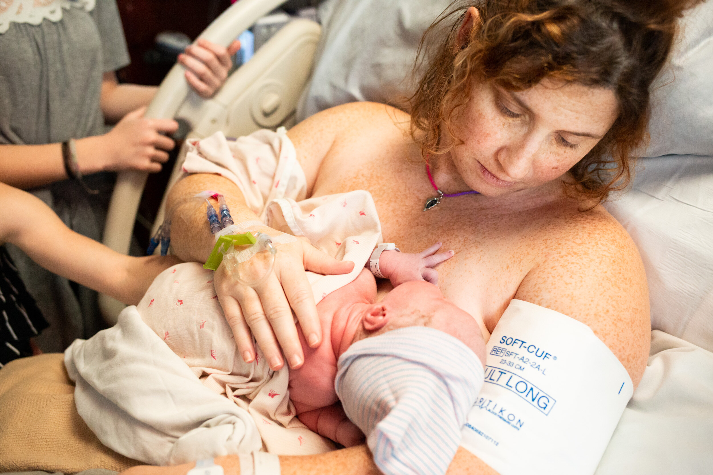 mom holding and nursing her newborn