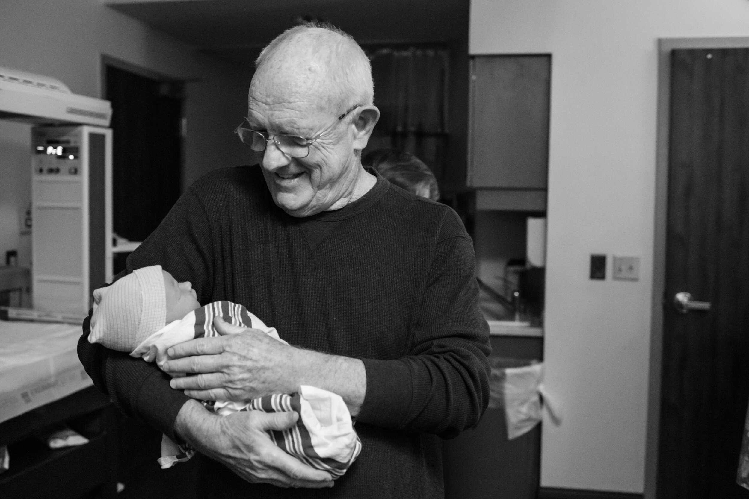 grandfather holding his new grandson