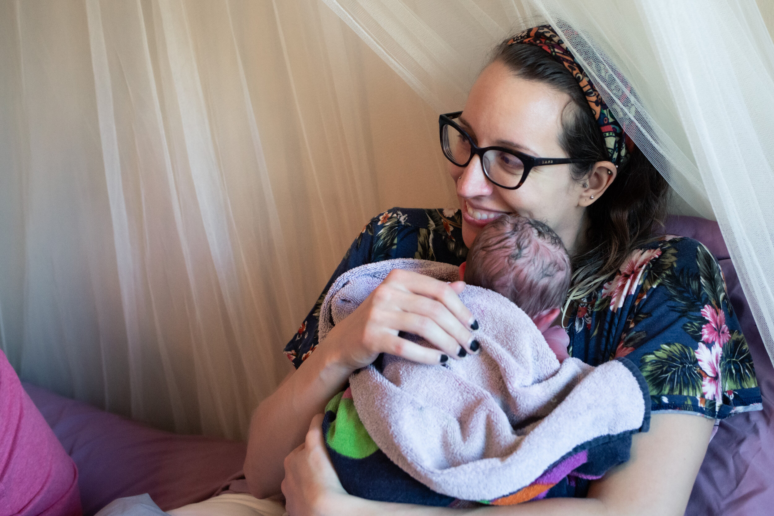 jacksonville mom holding newborn baby boy and smiling