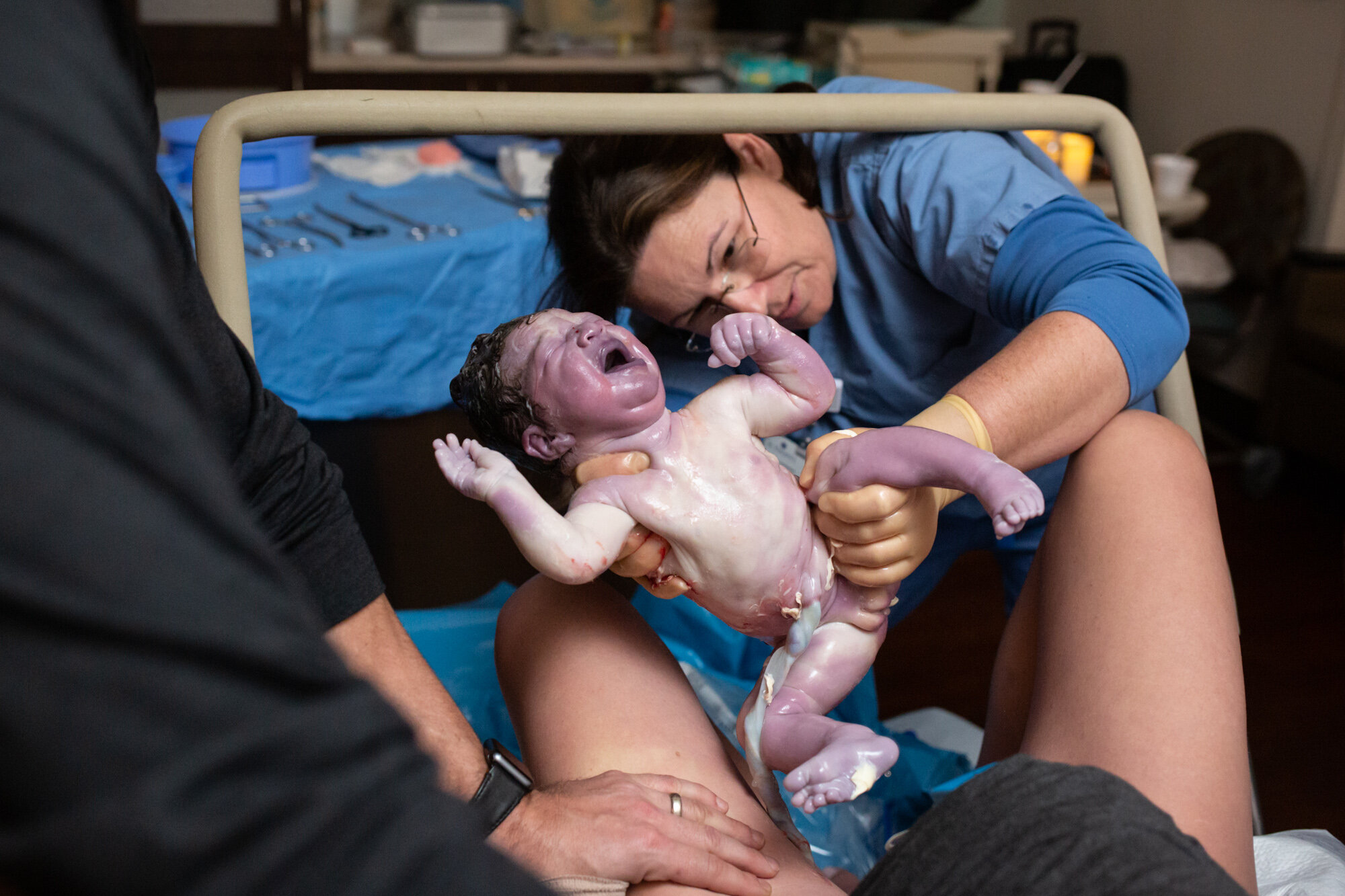 midwife holding up baby just after birth in a jacksonville hospital