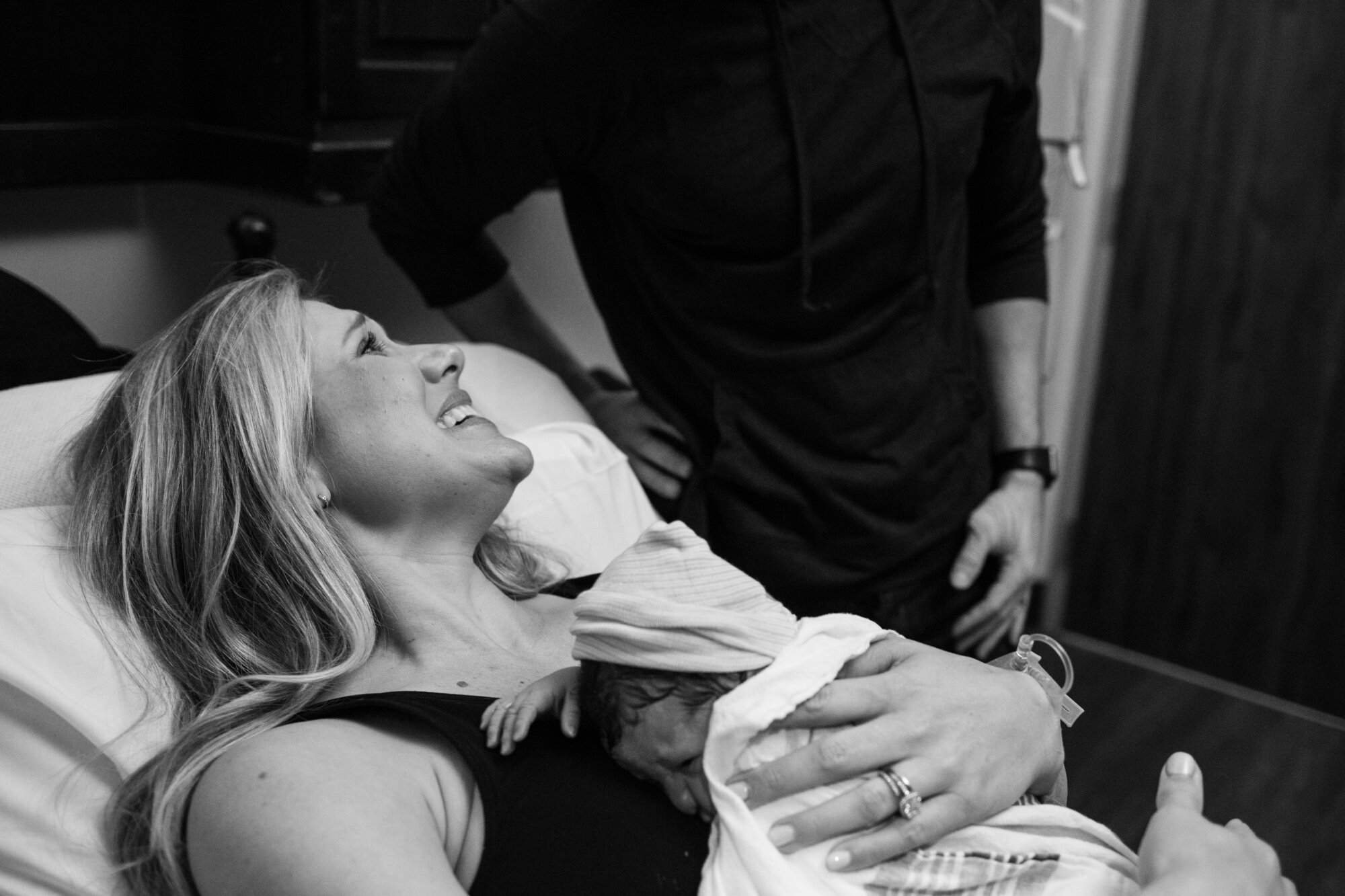 wife smiling at husband after birth of their baby