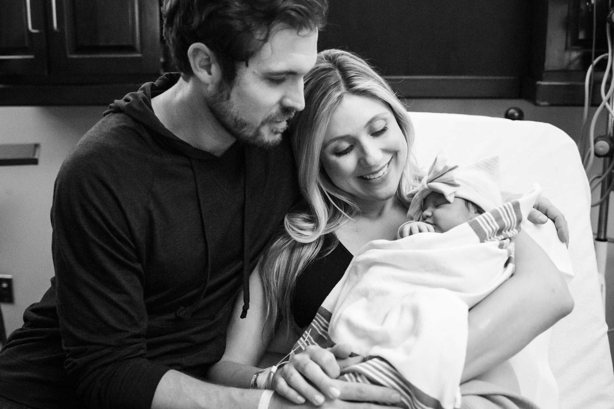 new parents holding their baby girl just after birth