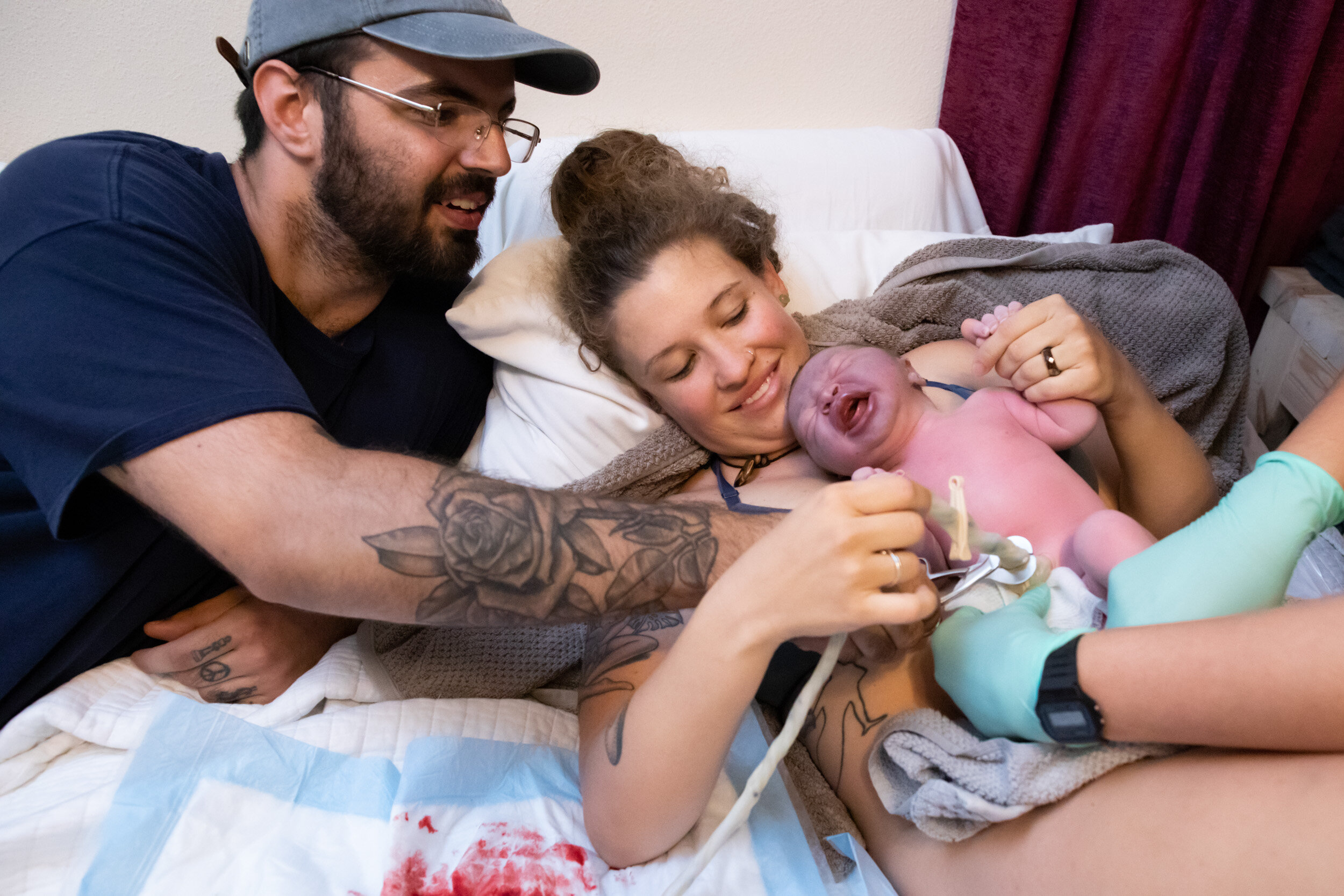new dad cutting the cord of his newborn son