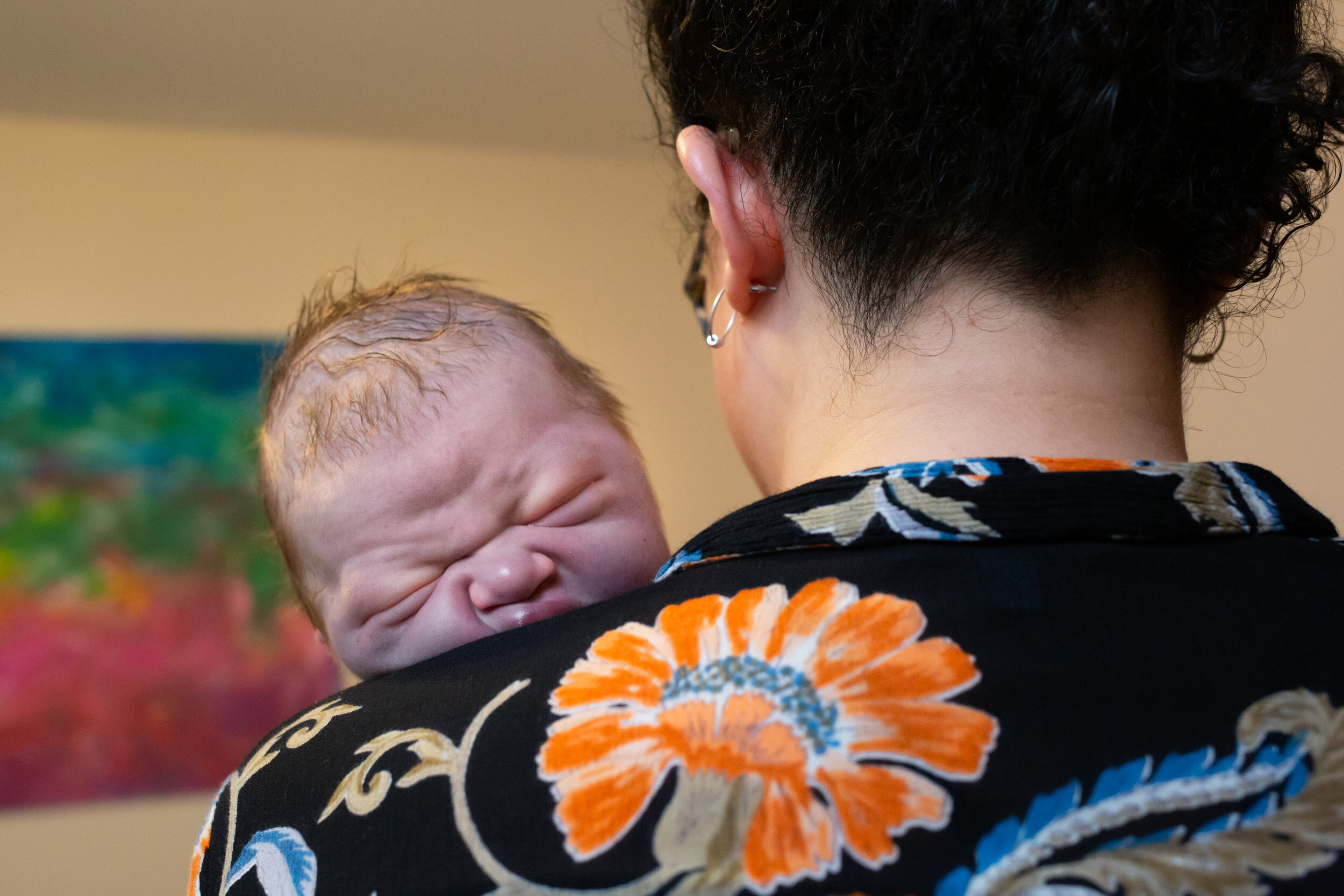 midwife holding newborn baby boy