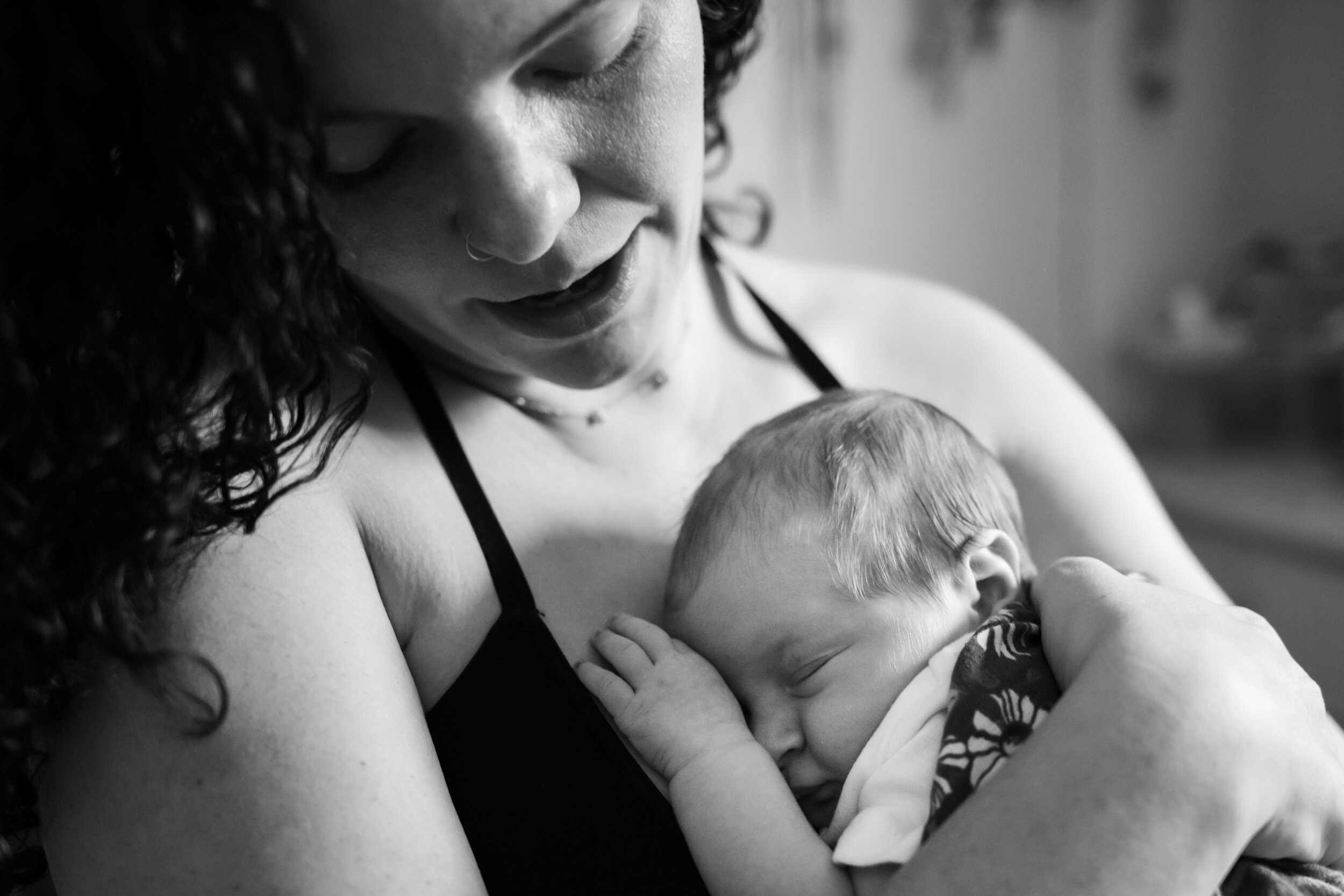 jacksonville mom holding and admiring her newborn baby girl