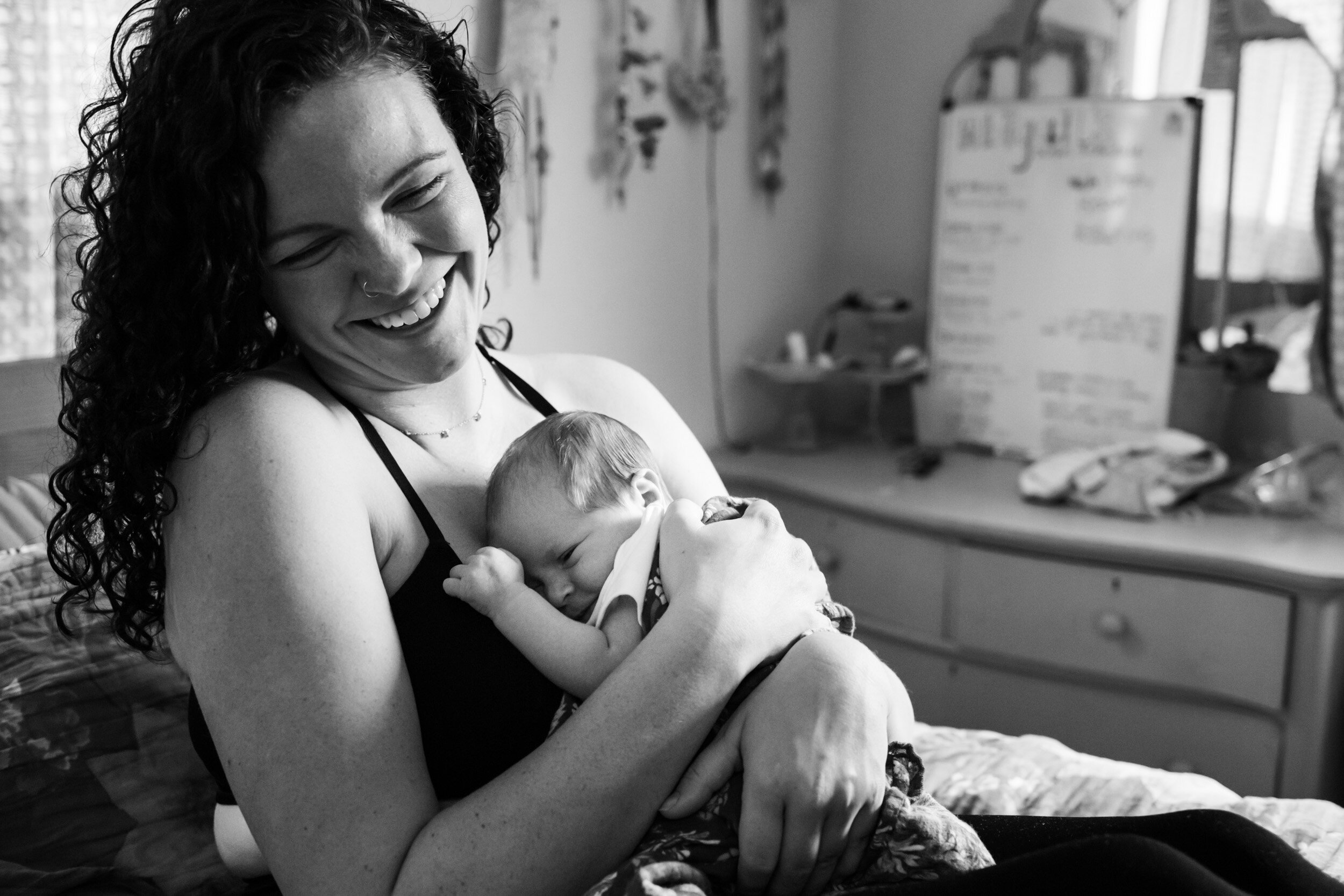 jacksonville mom laughing as she holds her baby girl