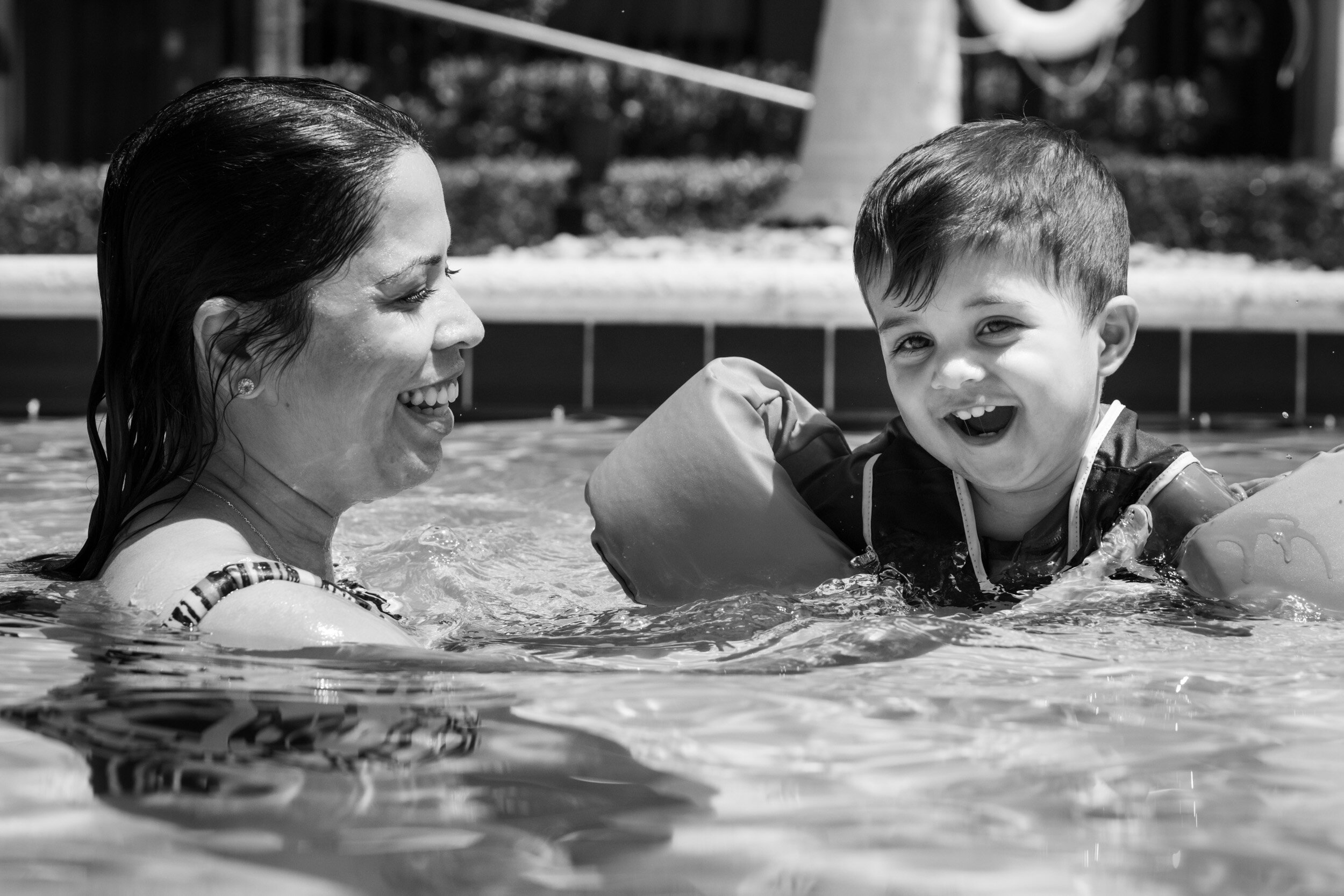 mom and child playing in the pool
