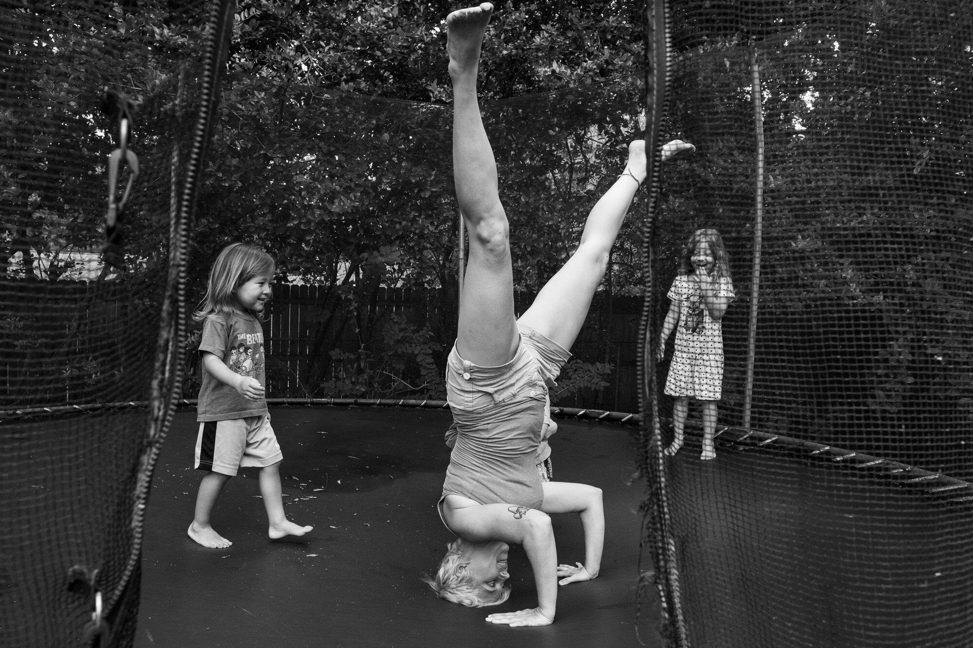 mom doing a headstand on trampoline