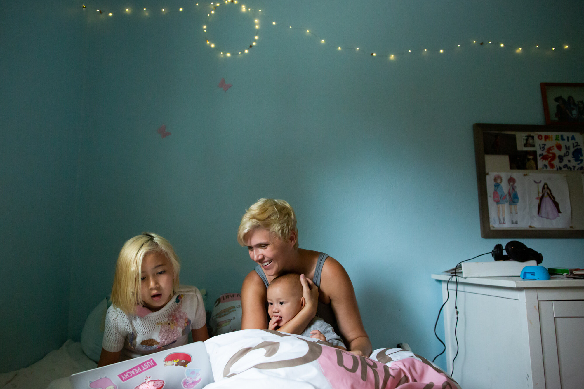 mom, daughter, and baby boy in bed