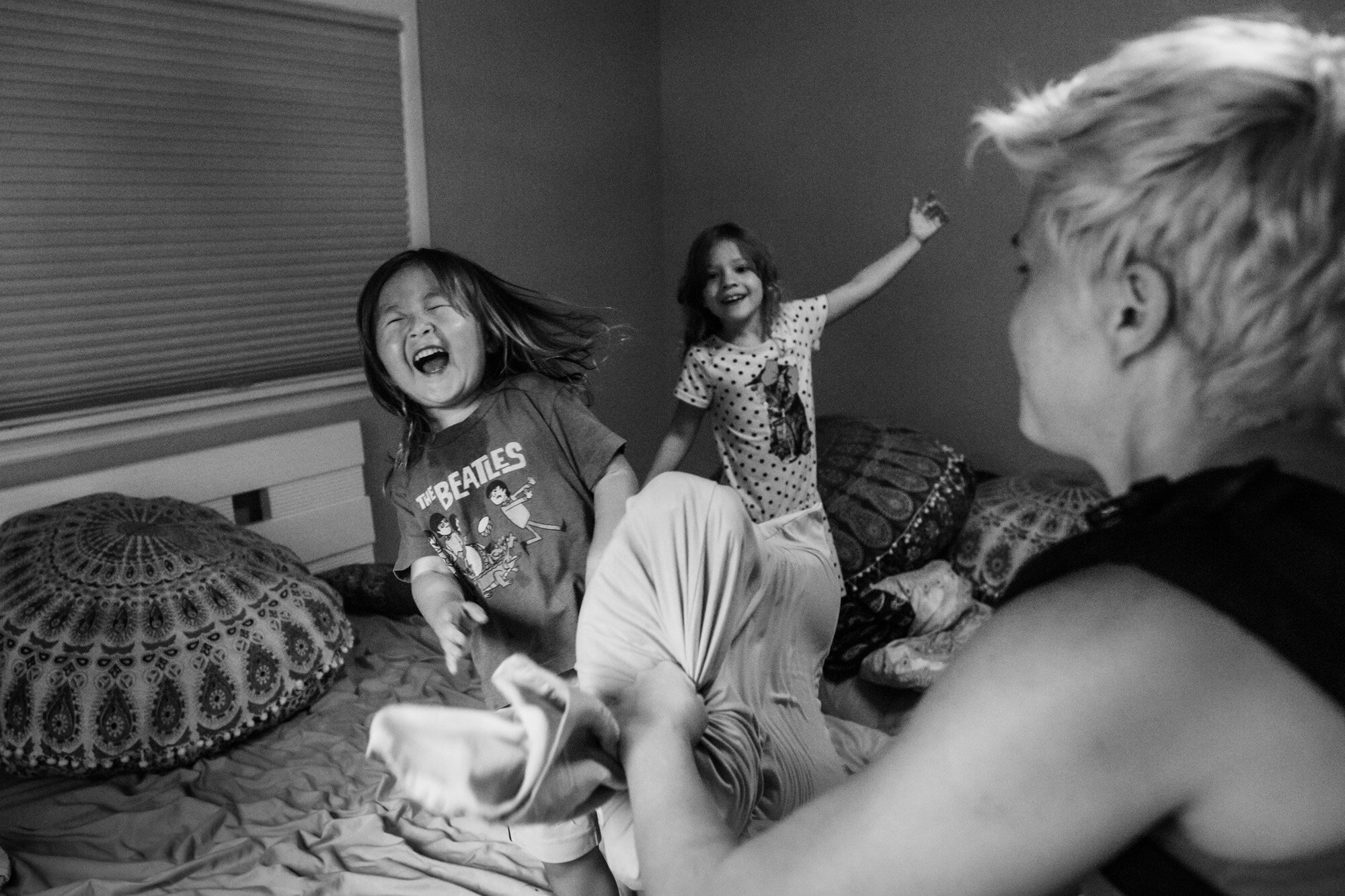 pillow fight with little boy laughing