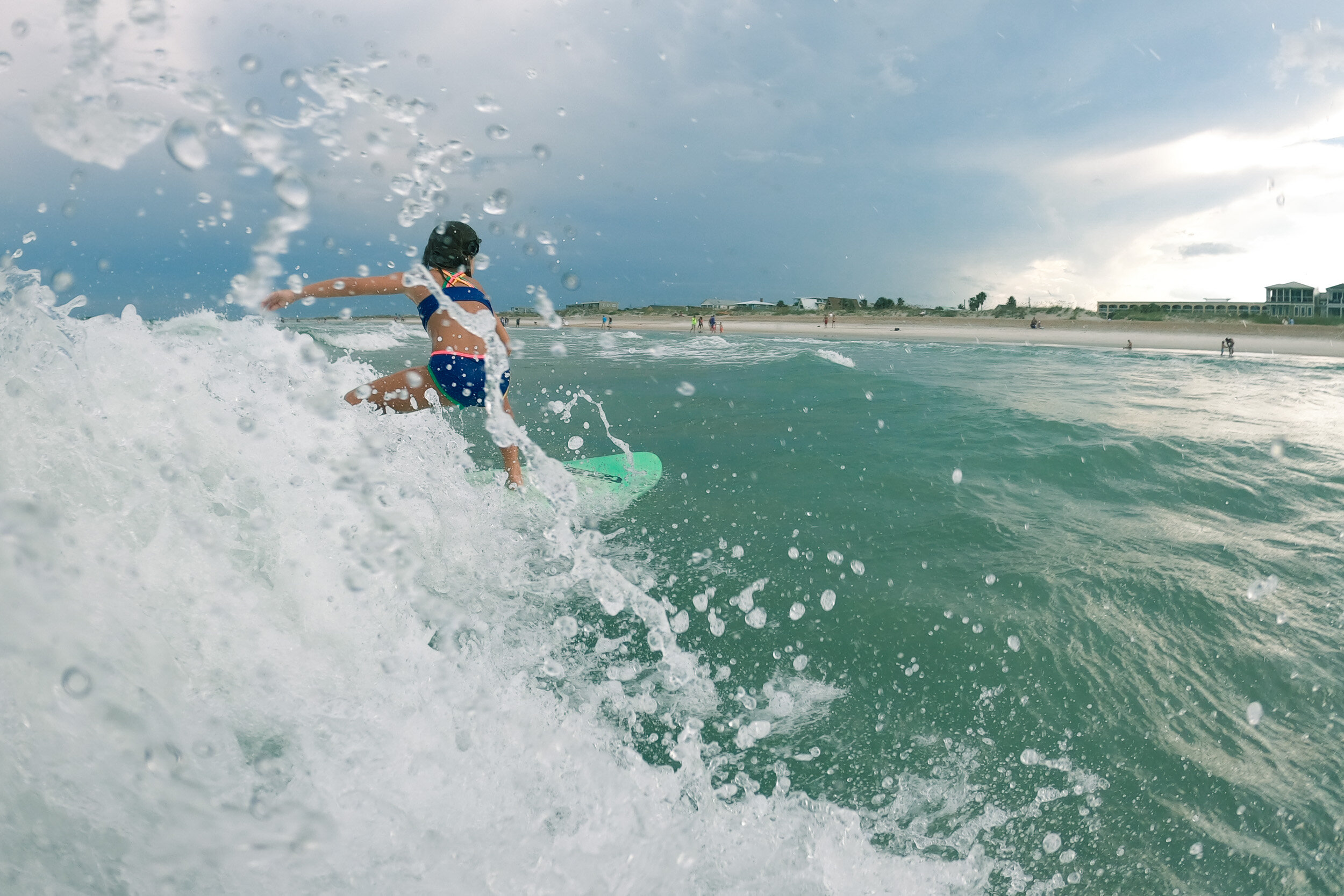 little girl surfing in st. augustine beach