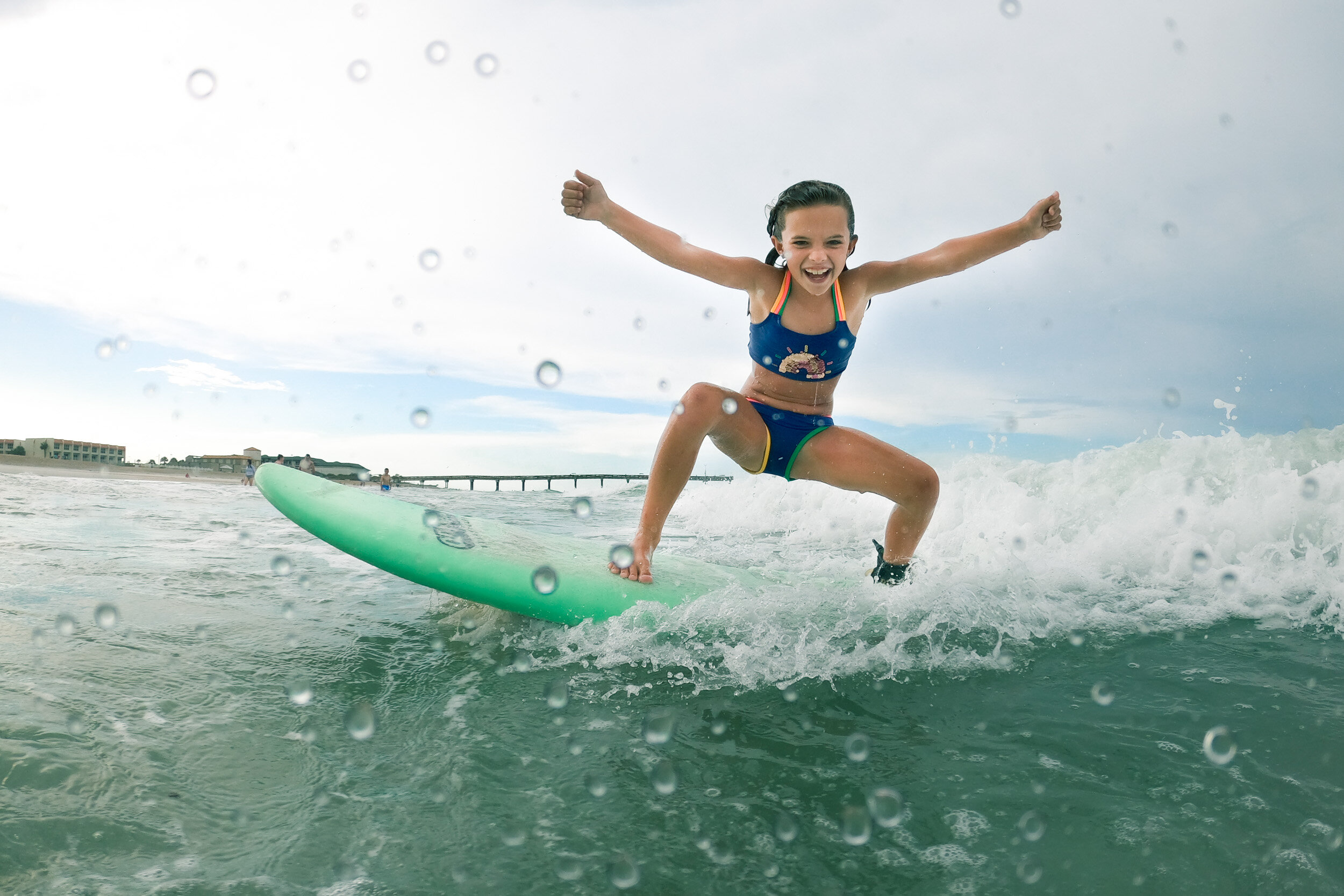 surfer girl catching a wave at anastasia island in st. augustine, florida