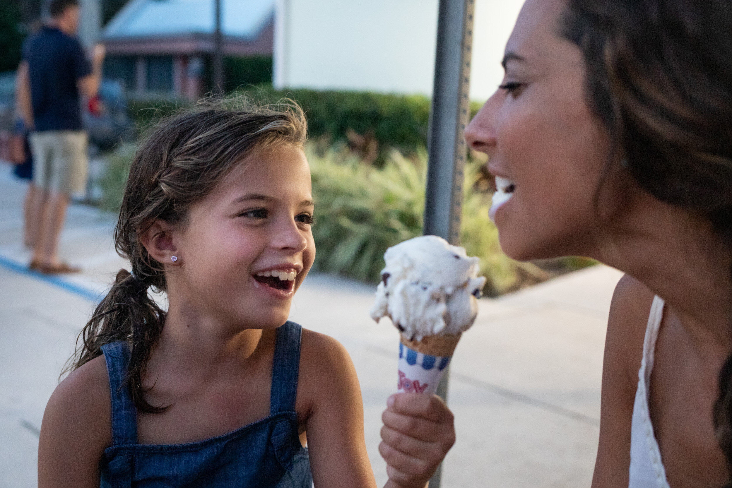 little girl feeding her mom ice cream at cone heads ice cream, anastasia island