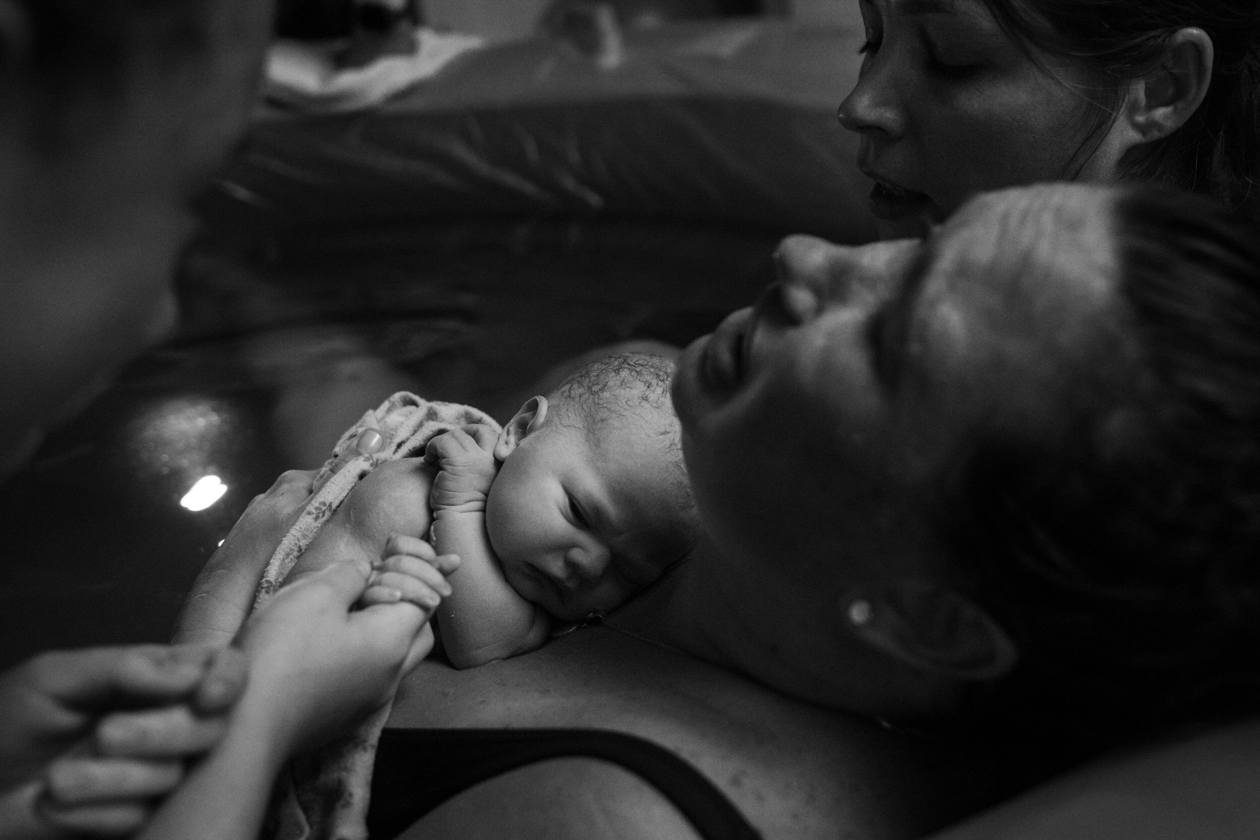 baby being held to mother's chest just after birth