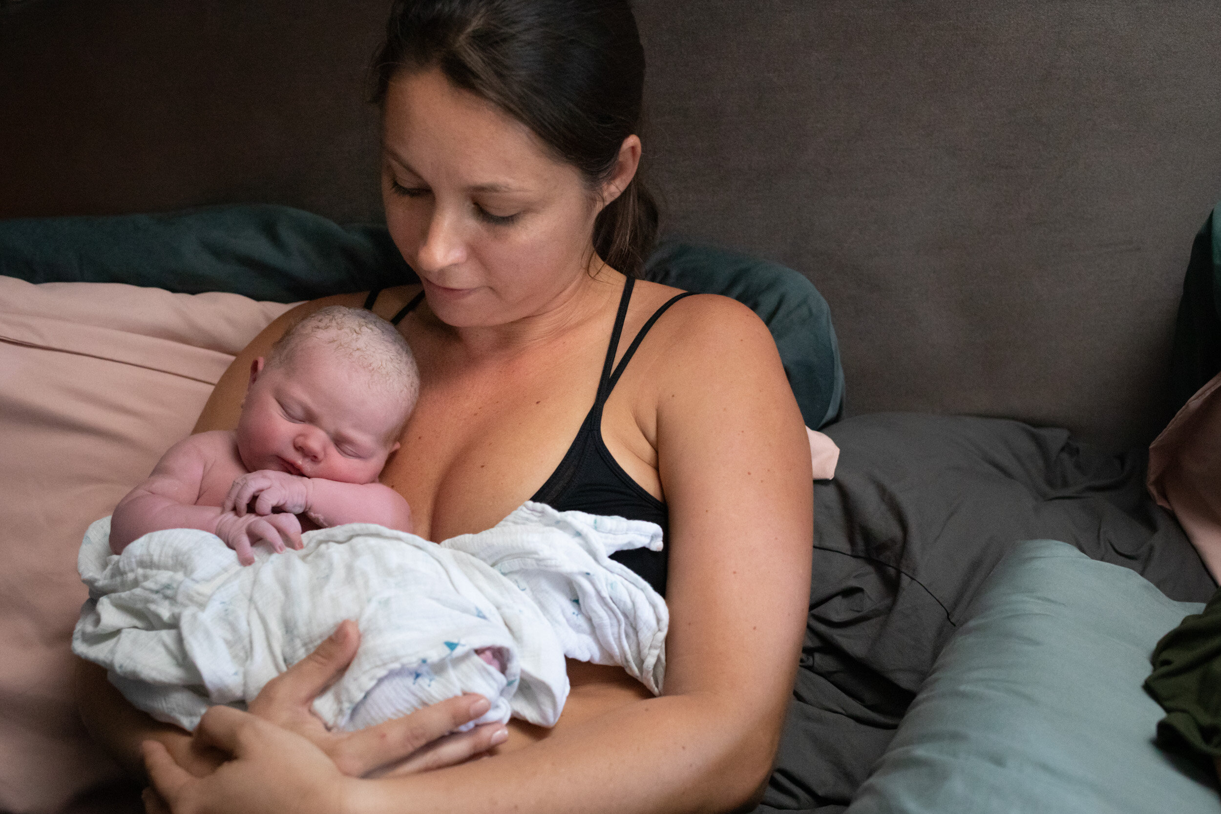 new mom holding her baby girl just after birth