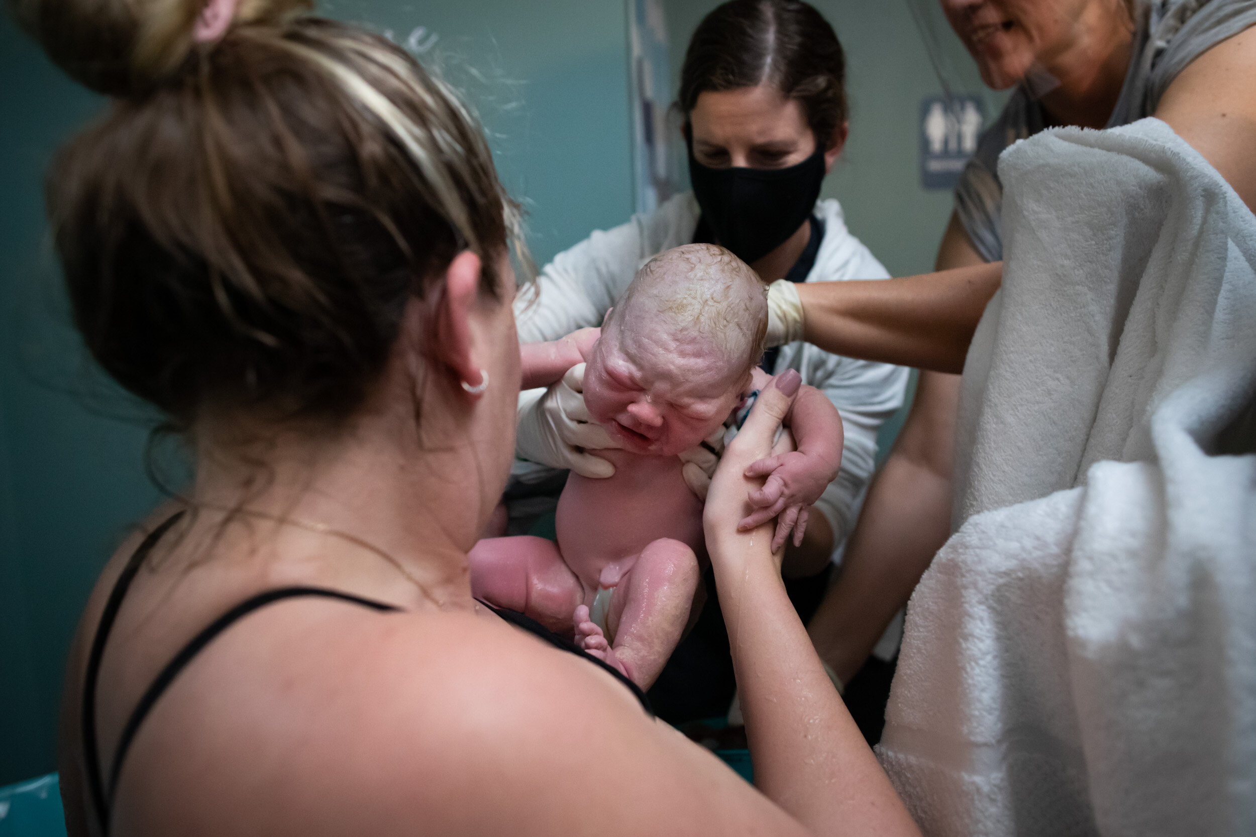 midwife holding baby