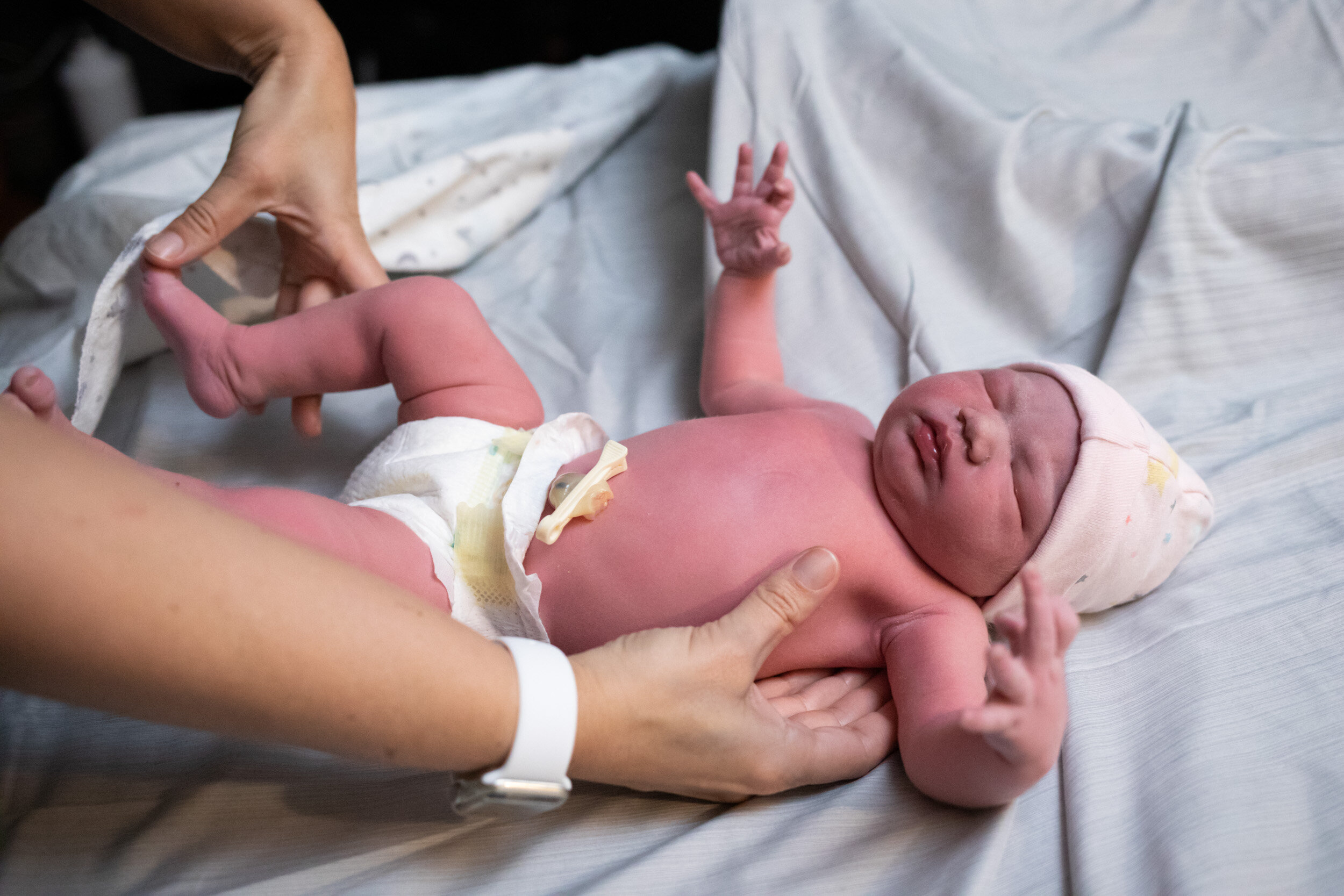 midwives assessing baby just after birth