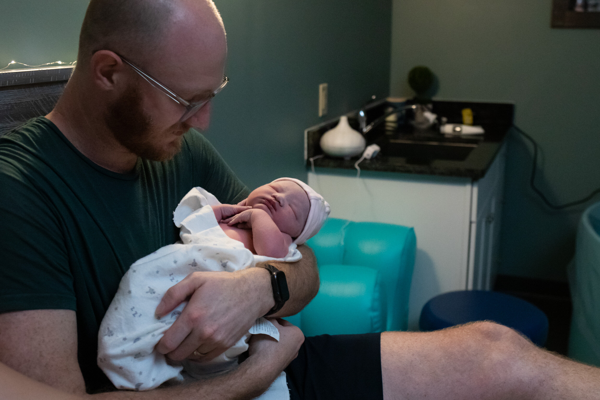 Jacksonville dad holding his newborn baby girl