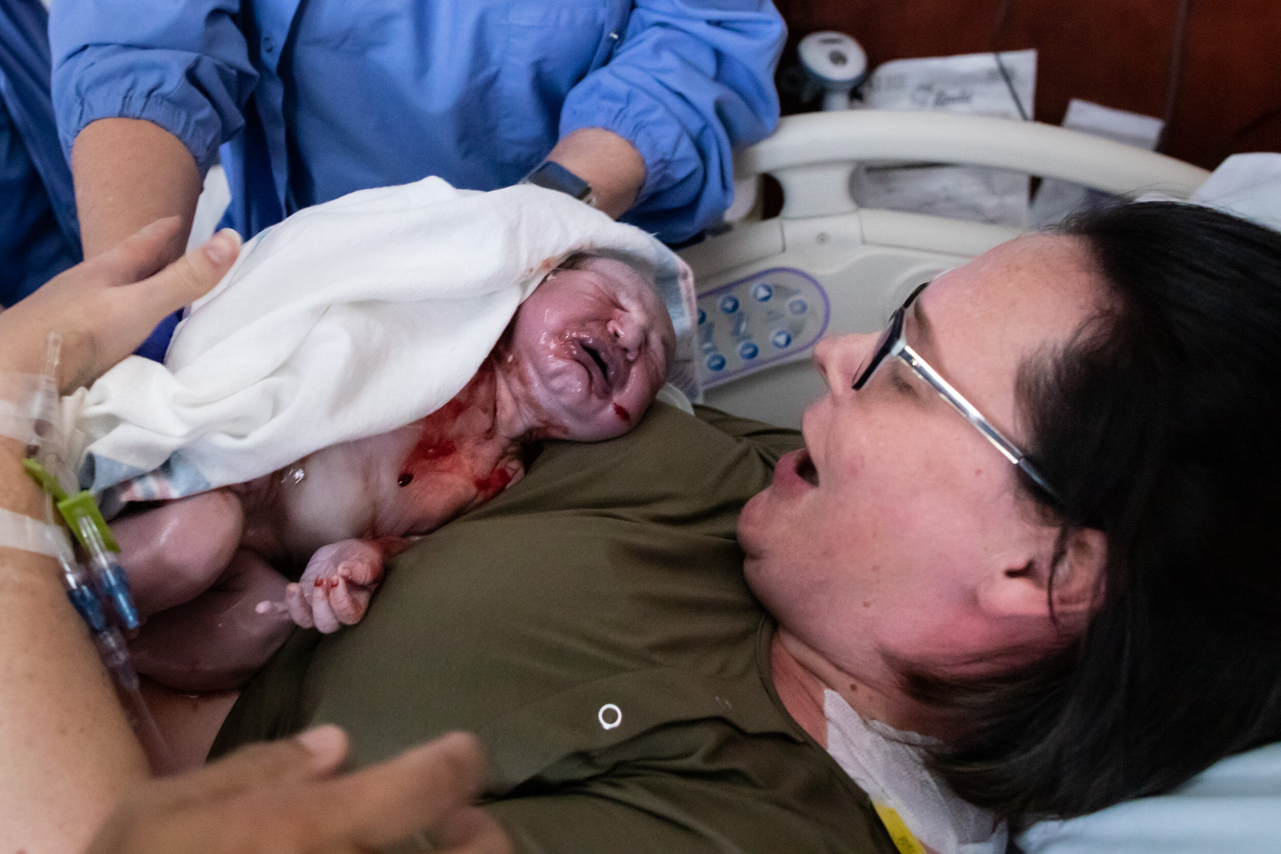 Jacksonville mom with joyful look on her face while she holds newborn infant