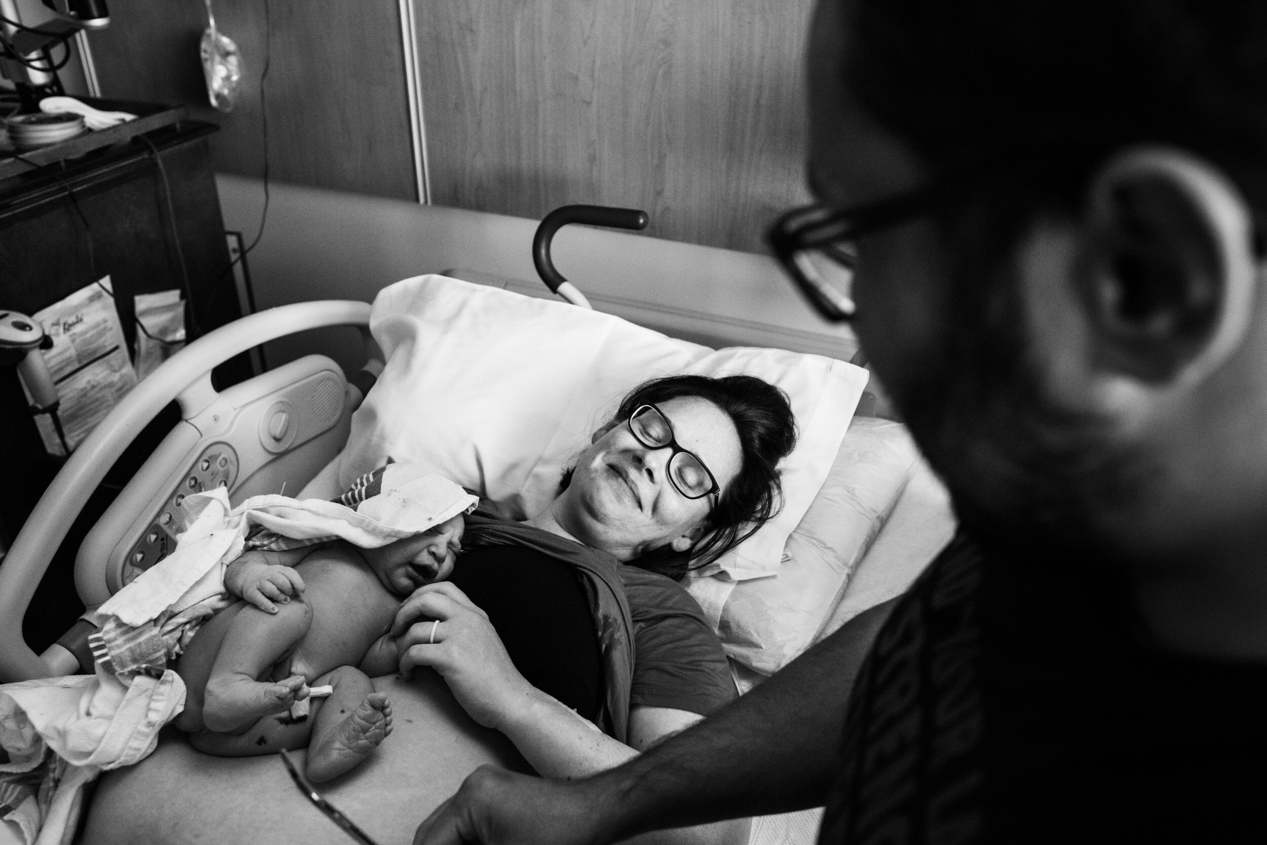 birth mom smiling with relief after her baby's birth