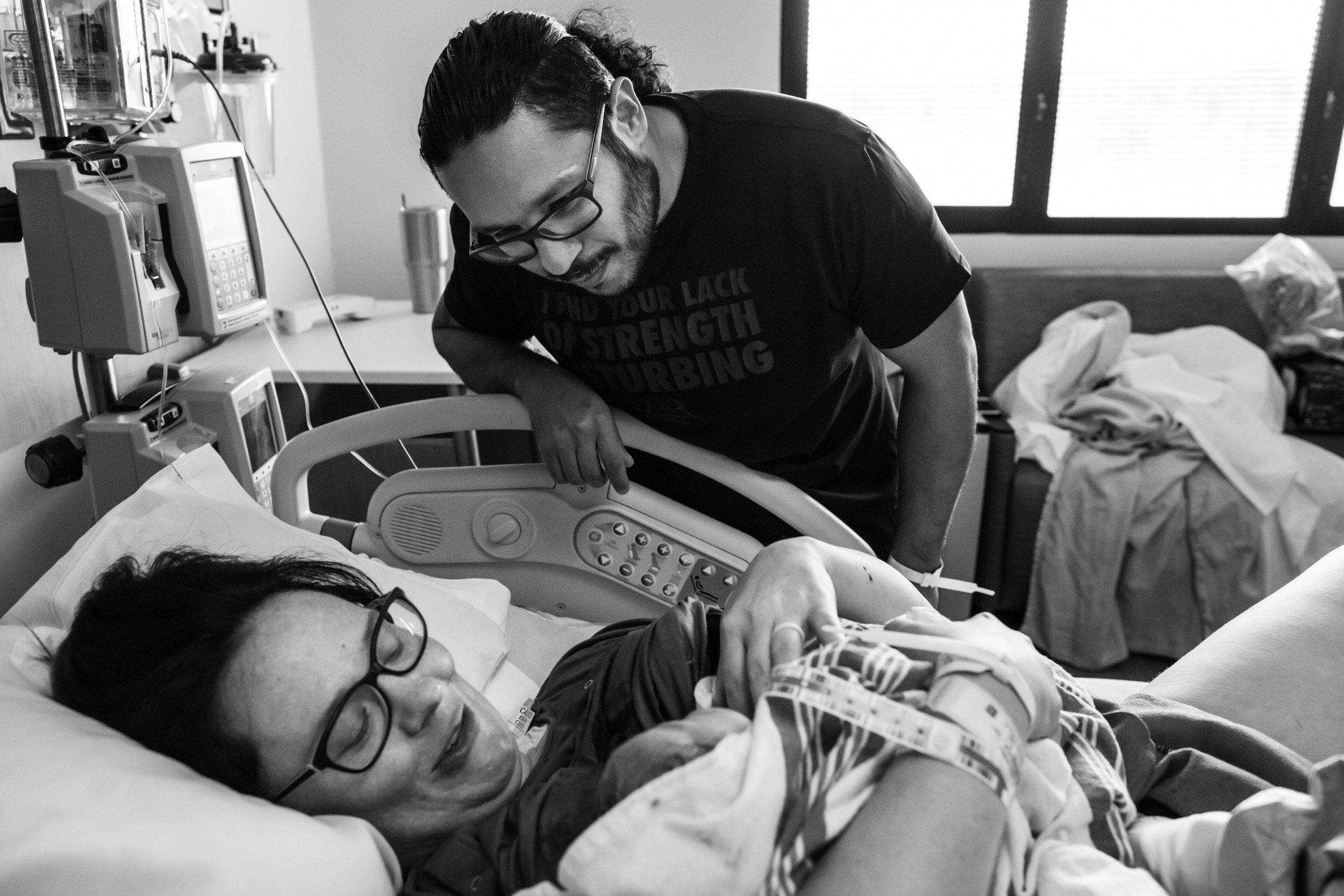 Jacksonville dad looking at newborn baby girl, just after birth