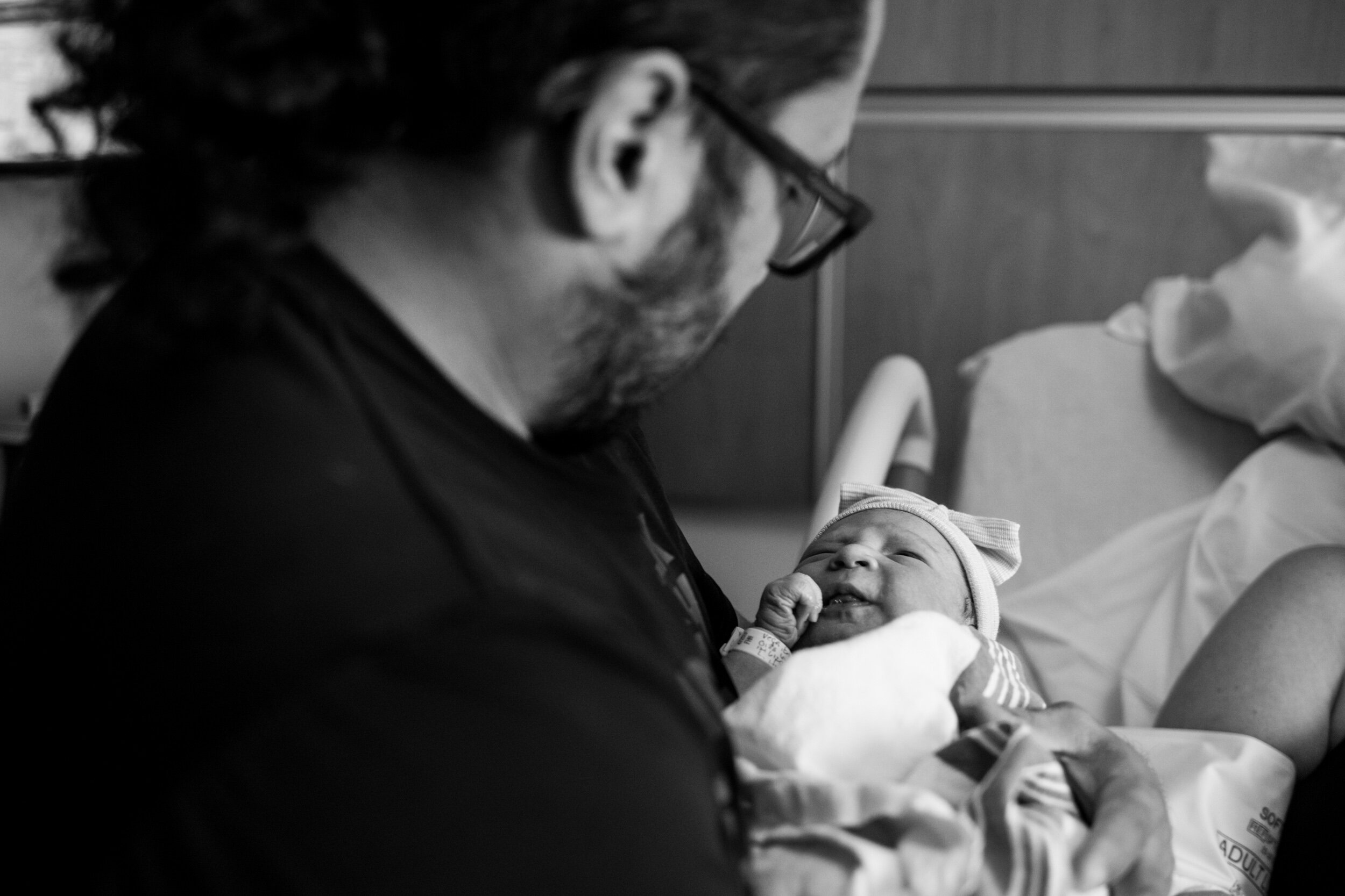 jacksonville dad holding his newborn baby girl just after birth