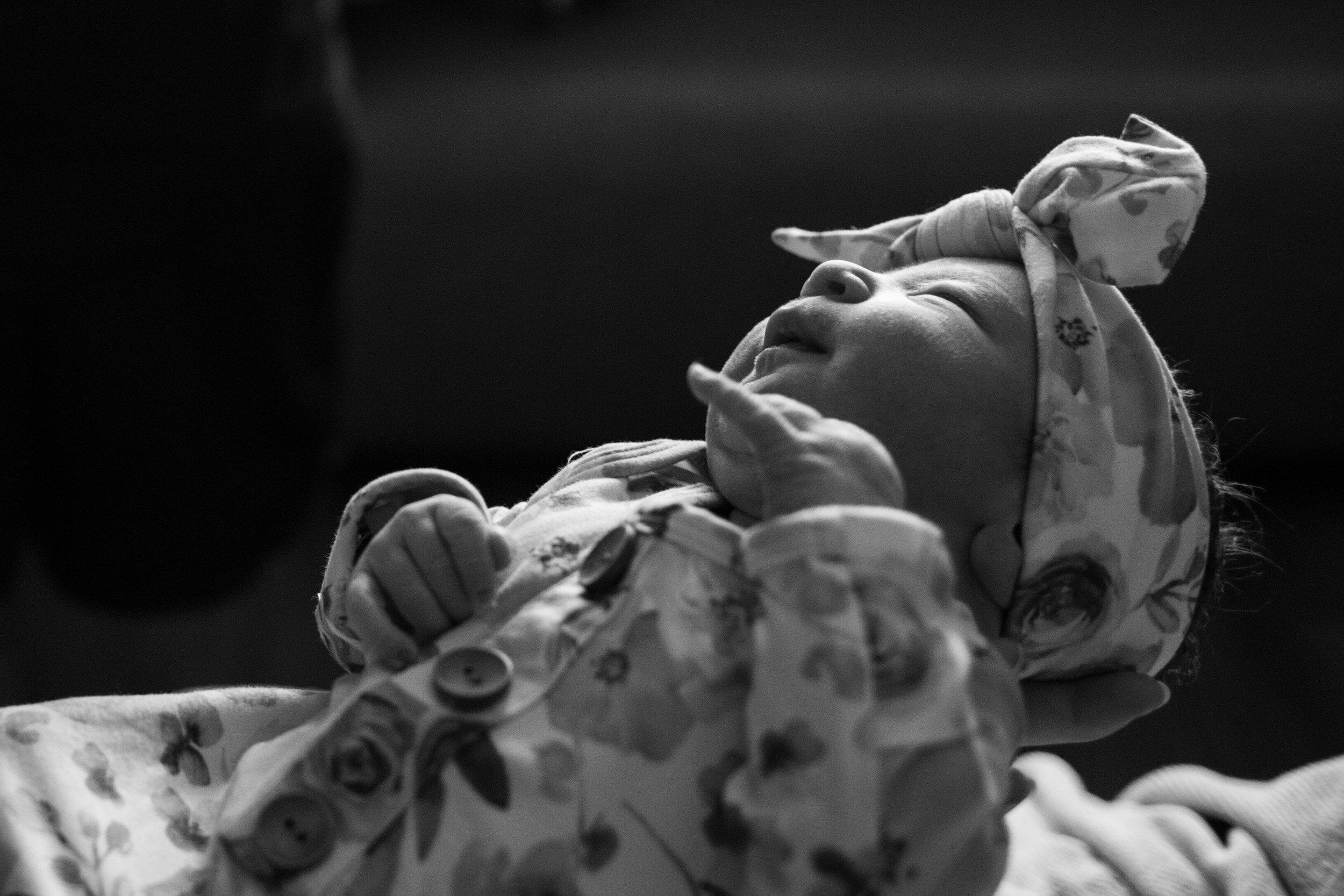 newborn baby with a hint of daylight on her