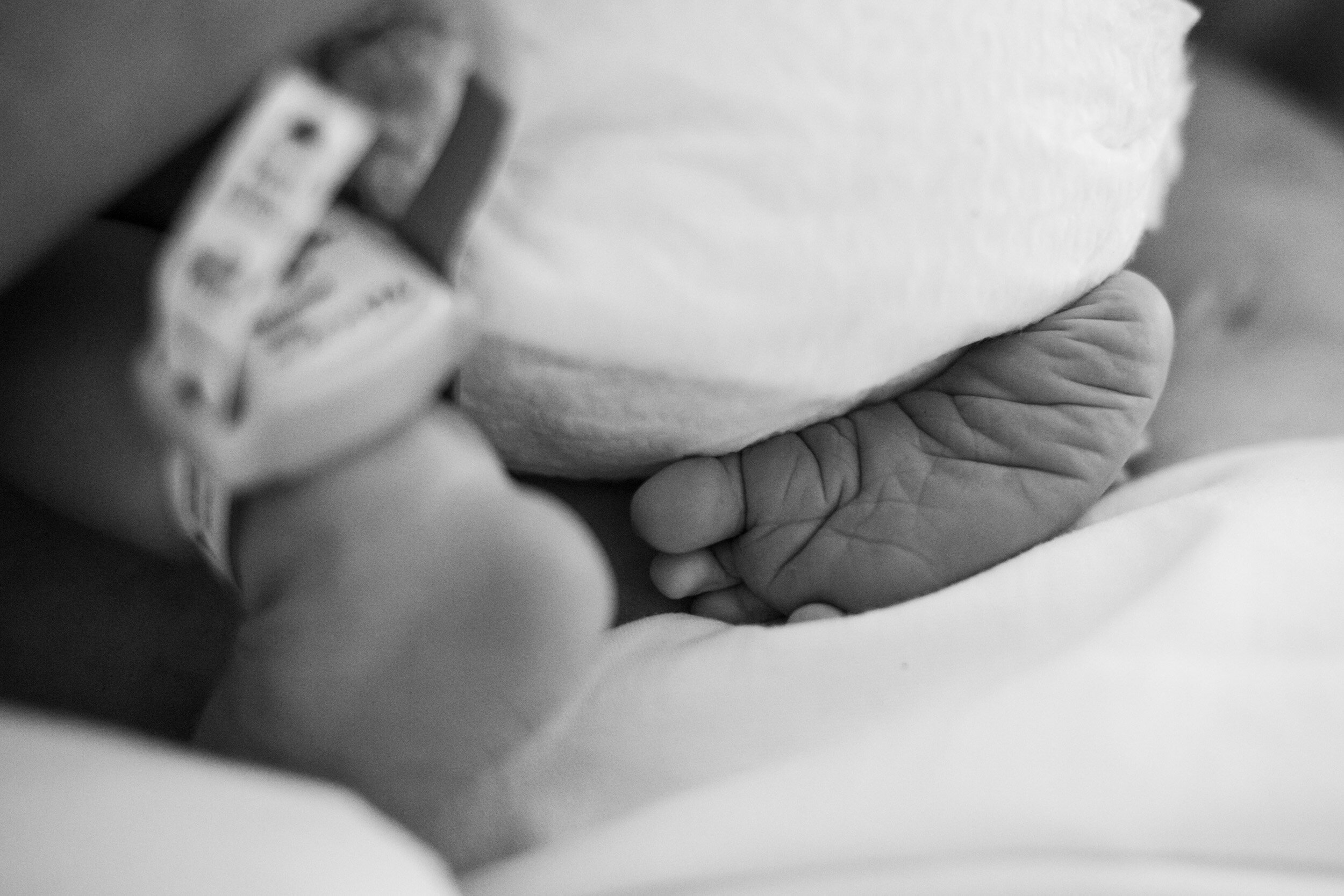 newborn baby feet on the bed