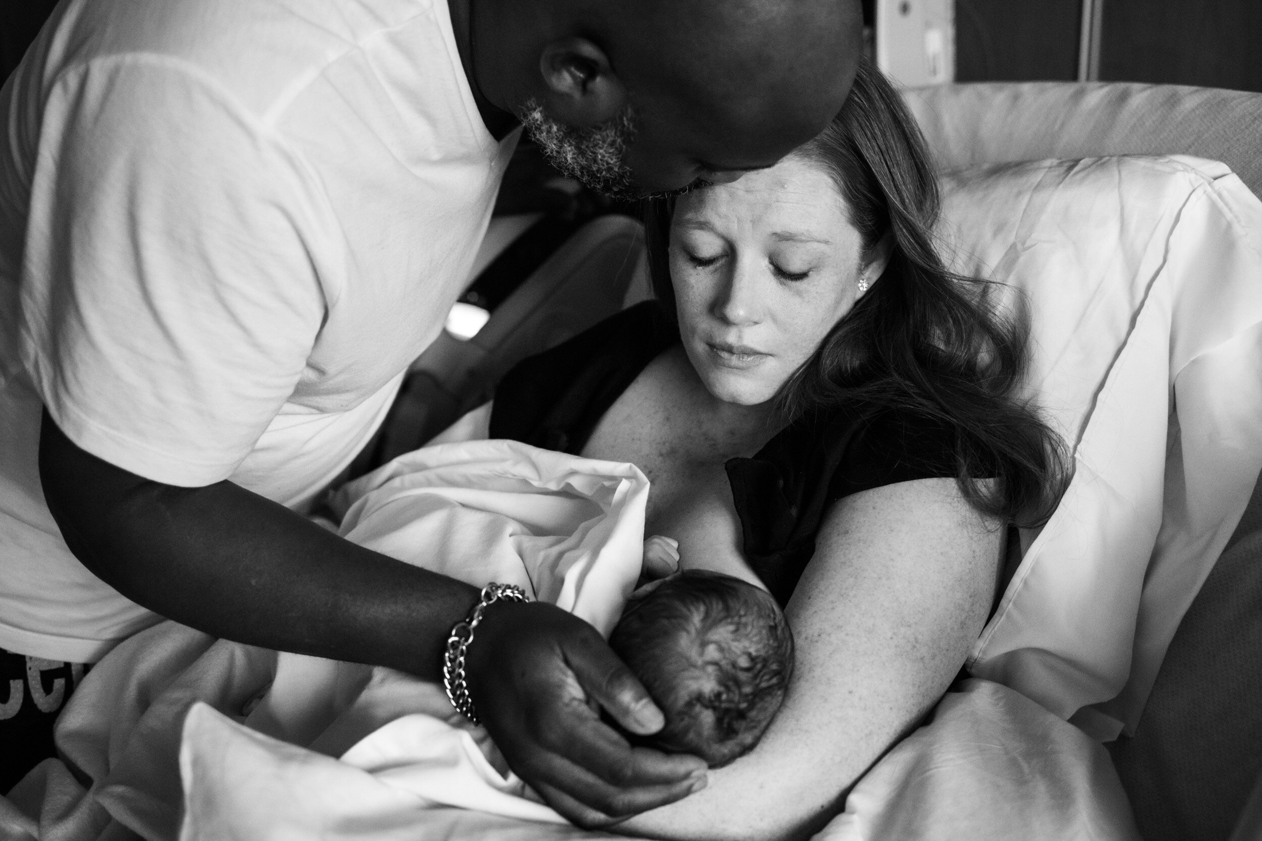 birth parents looking at newborn baby boy at Jacksonville hospital
