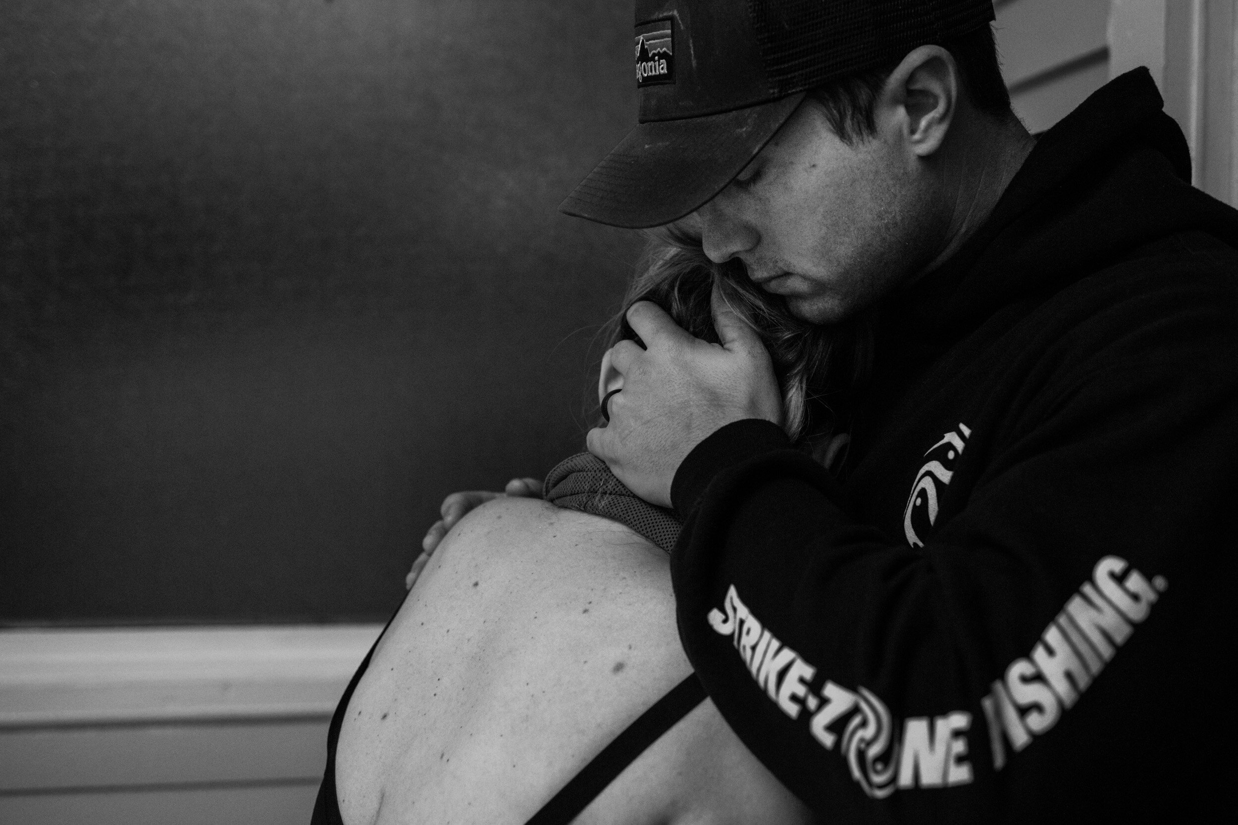 husband comforting wife who is in labor