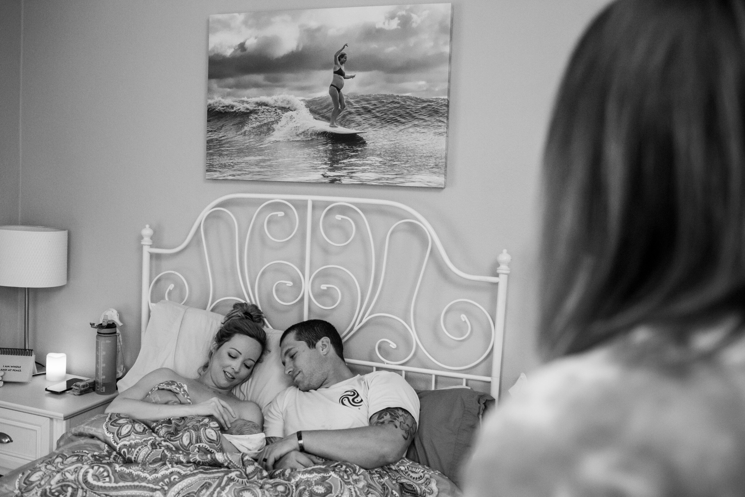 Jacksonville parents admiring their newborn baby while resting at the First Coast Midwifery birth center