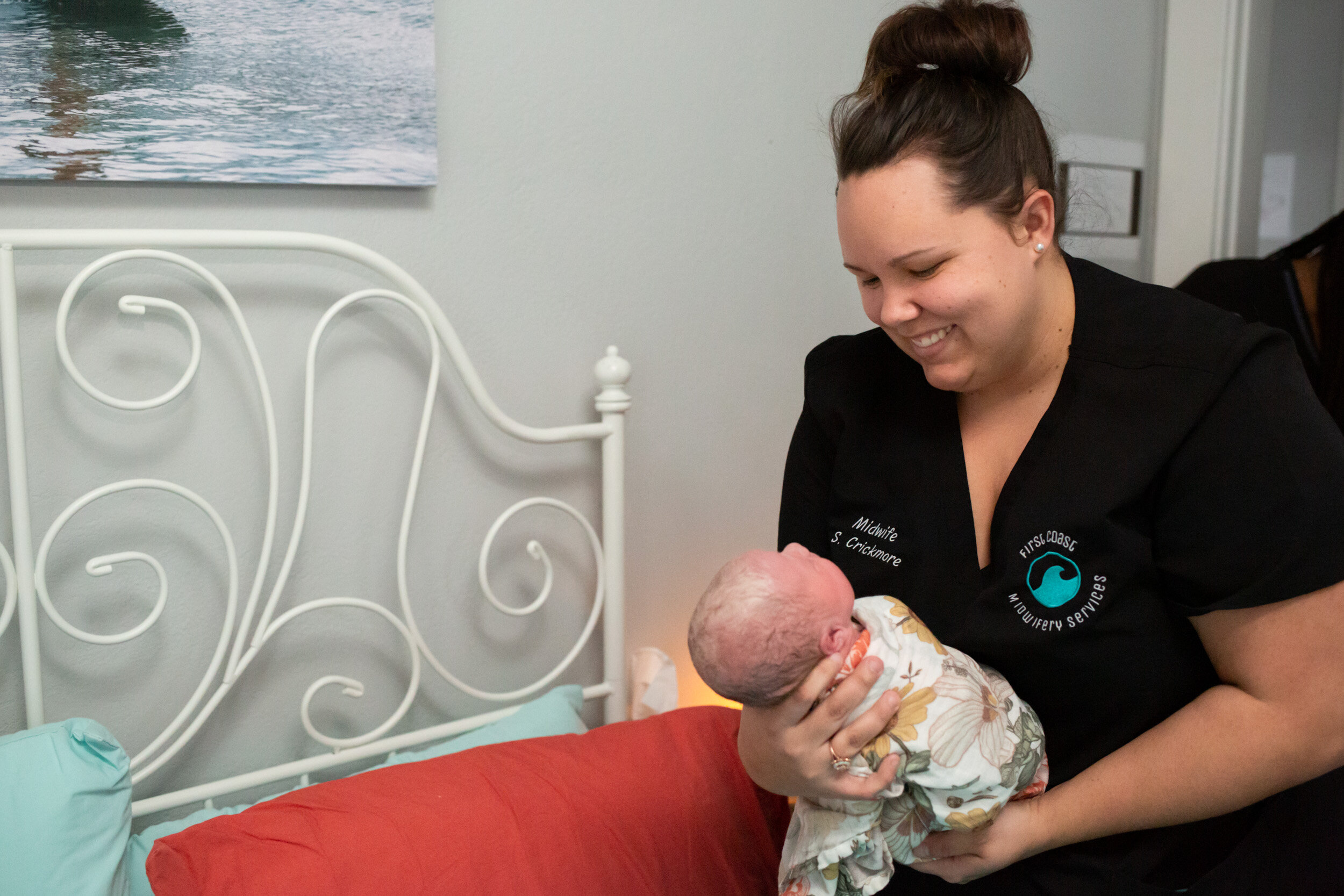Midwife Sam holding newborn baby girl