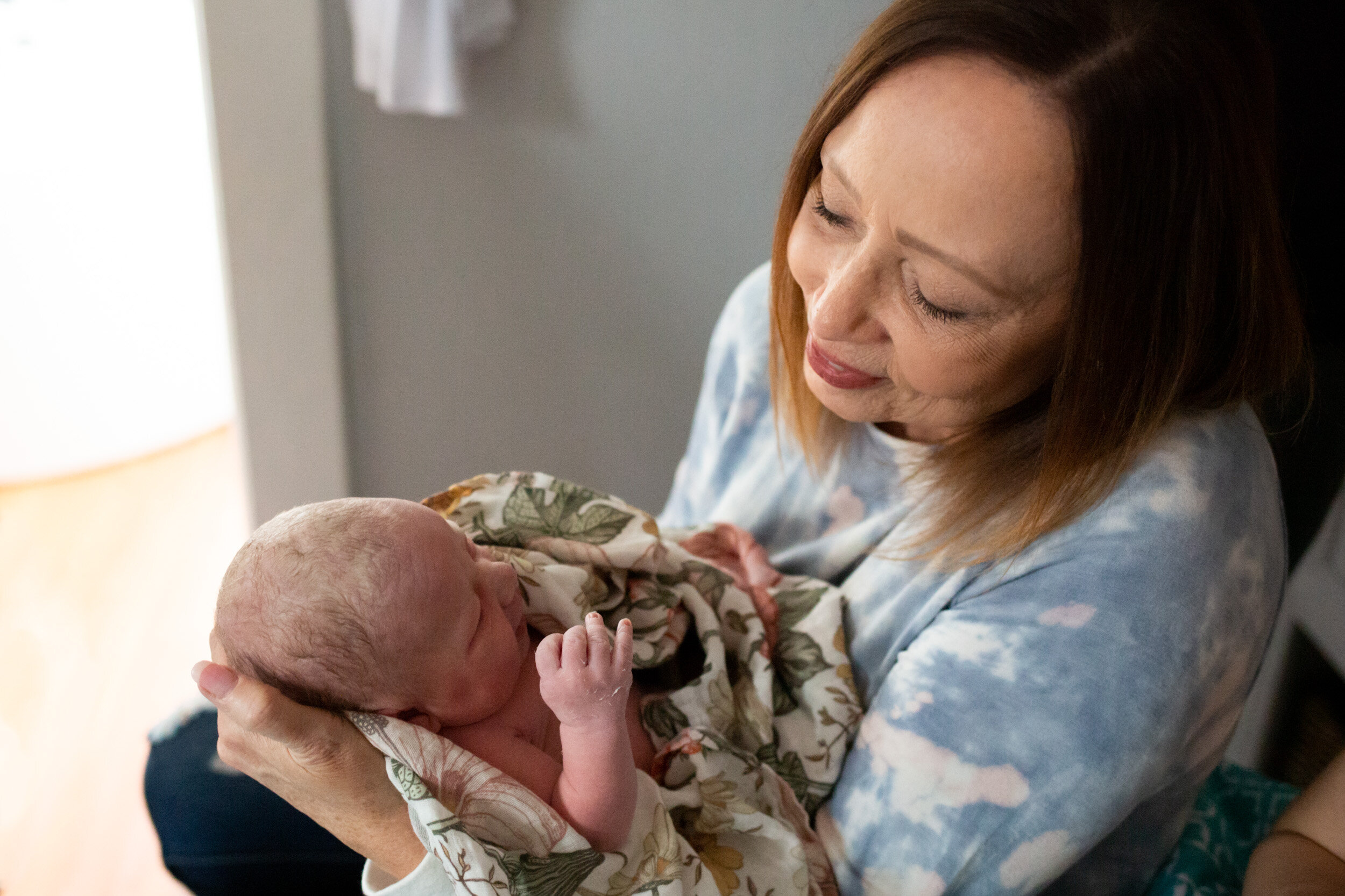 Grandmother holding baby girl just after birth